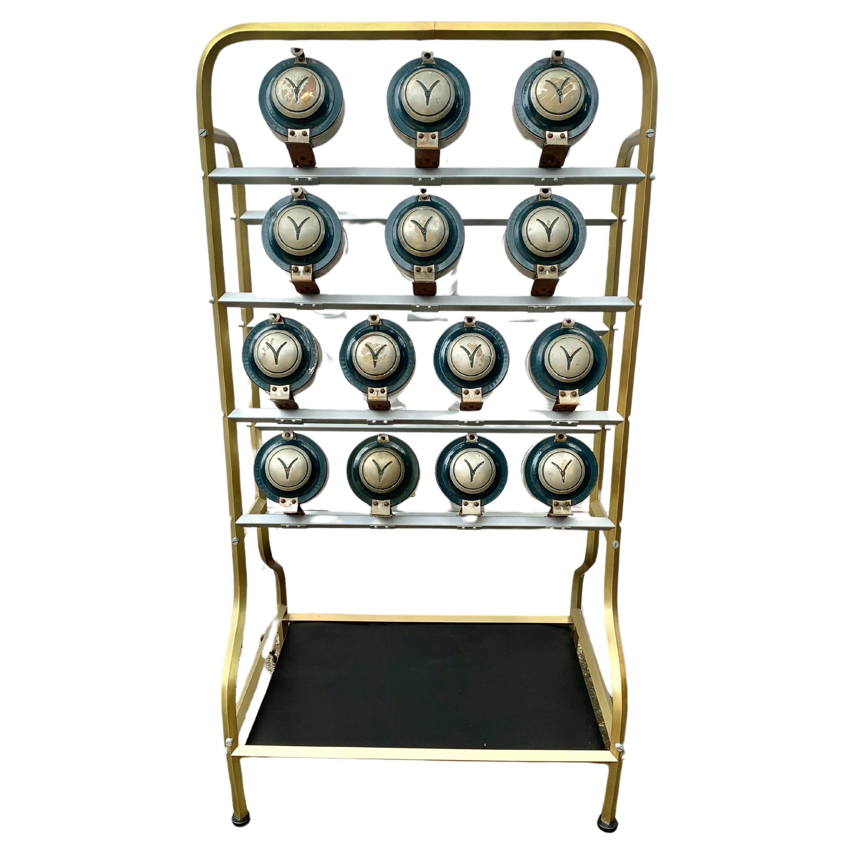 This Early 20th Century Caramelera or Candy Dispenser Display was manufactured in the early 1900's by the Argentinian company Vendo Solo. The piece features fourteen tube shaped jars with metal hinged tops that are mounted in four rows on a metal