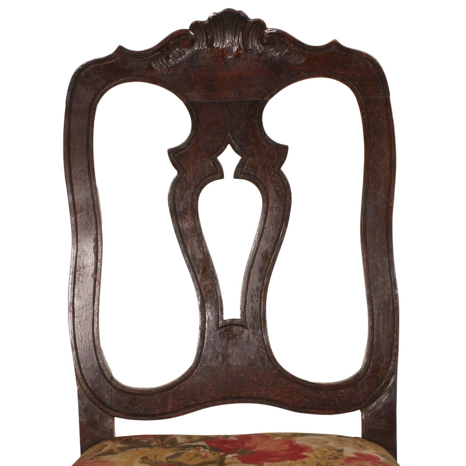 Early 20th century Venetian baroque chairs in hand-carved solid ebonized walnut. Contoured backrest, seat supported by springs and original belts of the time. Floral patterned upholstery recently replaced, in good condition.

Measures in cm: H