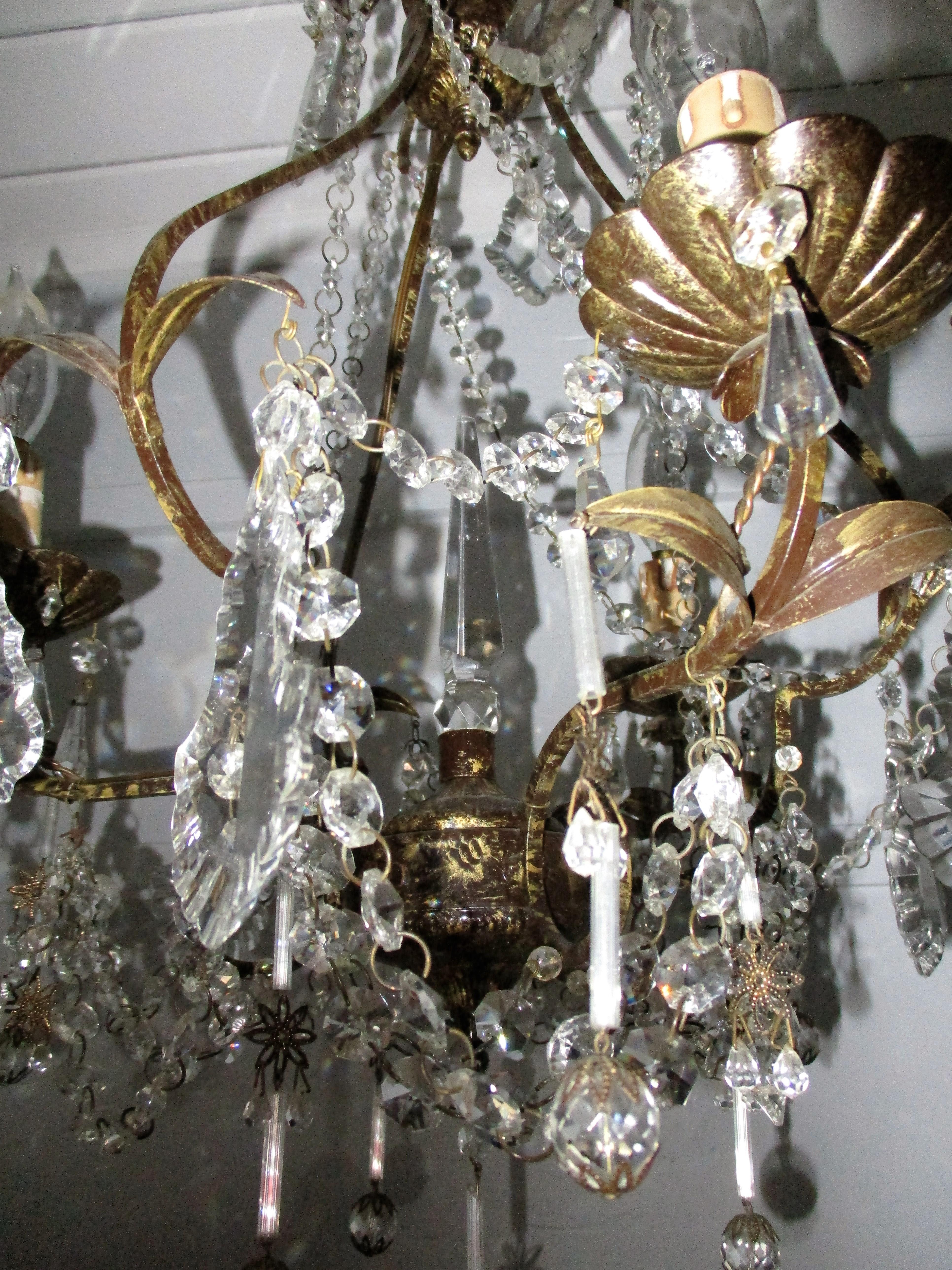 Whimsical 3-light Venetian chandelier adorned with French pendalogue prisms, beading, stars, tiny crystal balls and spear spike finial.