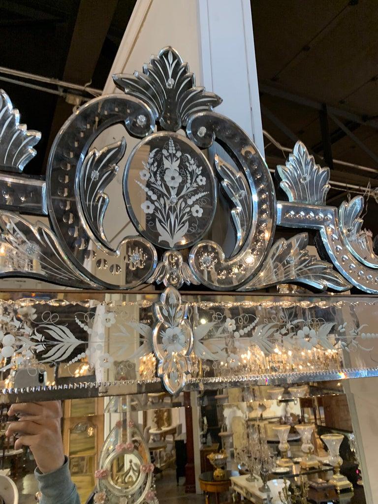 Majestic early 20th century Venetian etched glass palace size mirror. Etched floral images along with a beautiful crown at the top. A fabulous piece that makes a real statement. Exquisite!
Note: There are 2 medallions missing on the bottom corners.