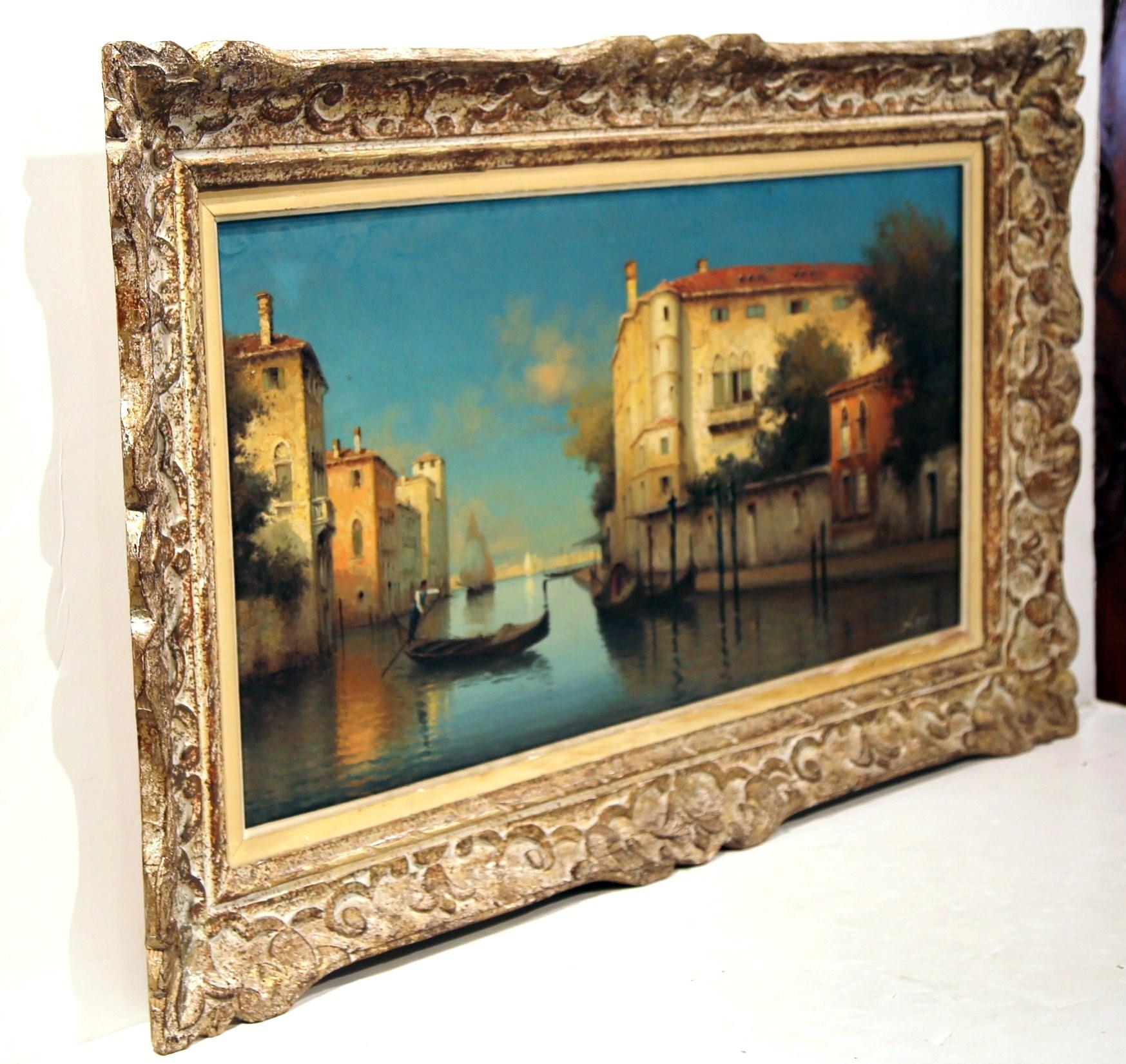 This beautiful antique Venice oil on canvas painting was created in Italy circa 1920. Set in the original carved and painted frame, the art work depicts a sunset on the Venice canal with gondola and Venetian palaces on both sides. Great sunset