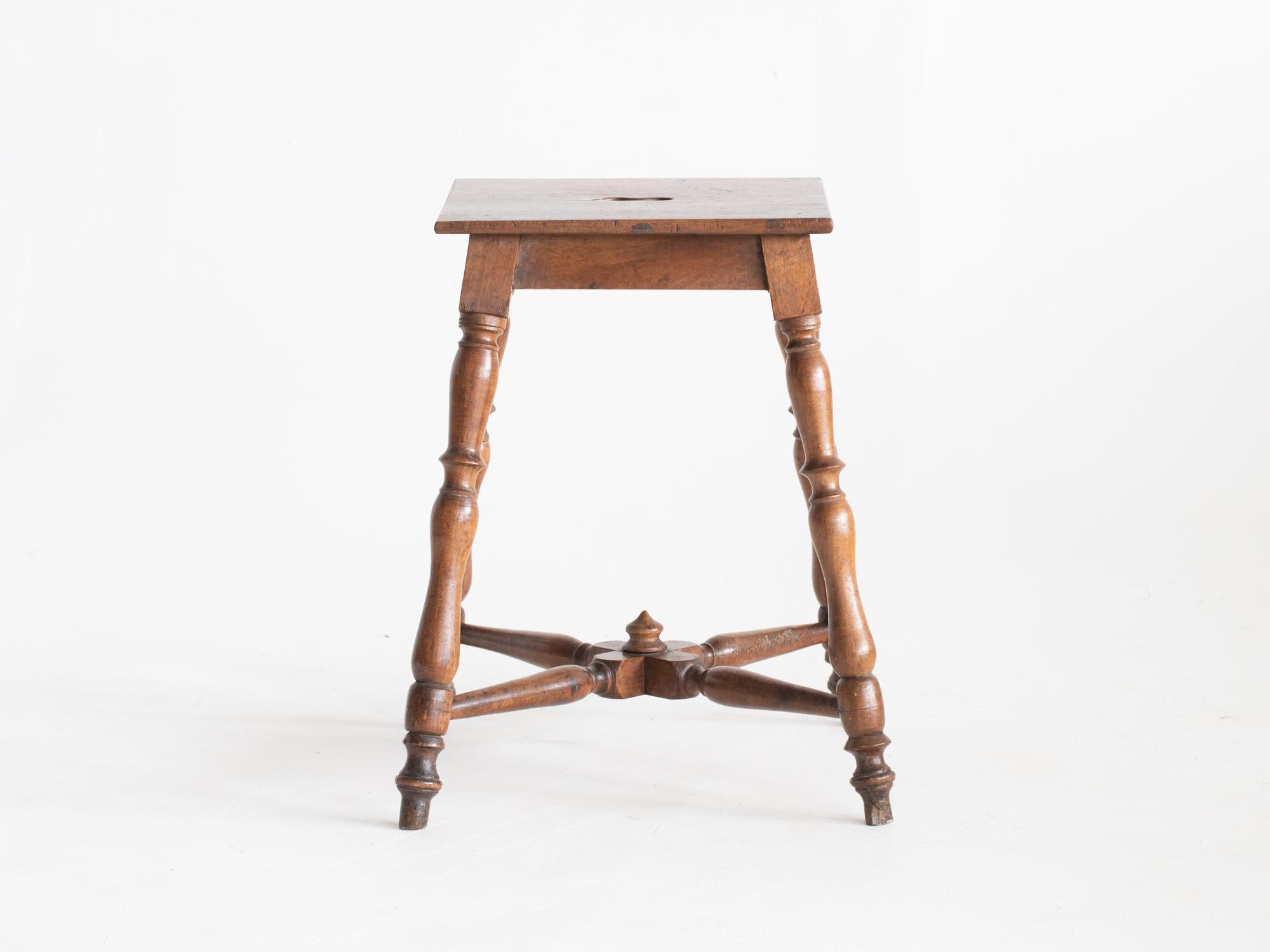 A vernacular French walnut stool raised on turned legs, 19C.

In good sturdy order with charming wear and patina.

55 x 46 x 46 cm (21.7 x 18.1 x 18.1 