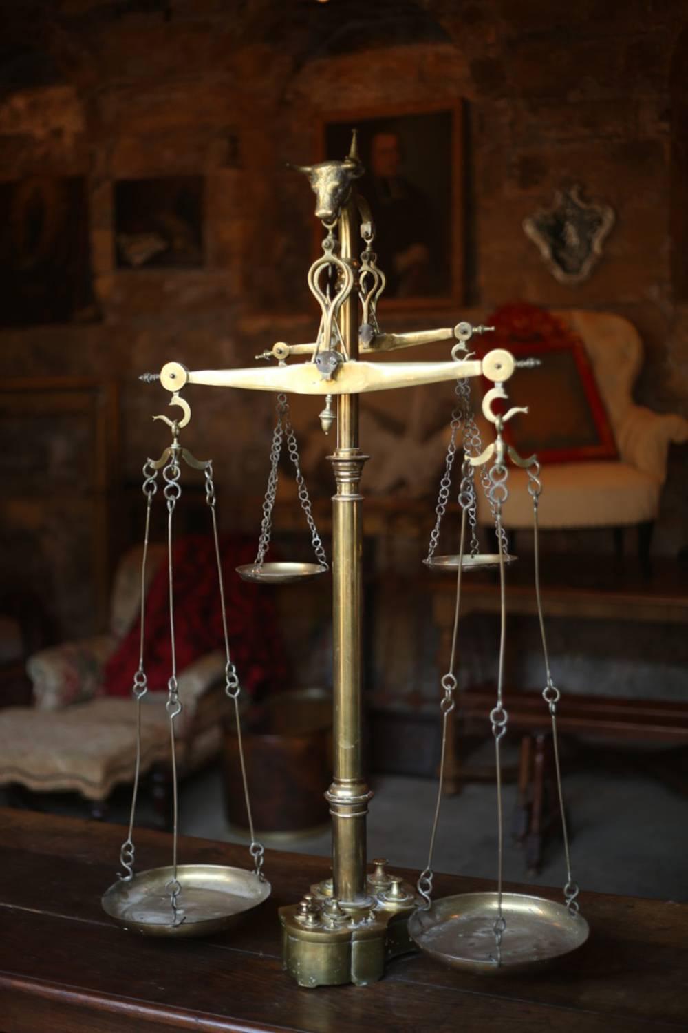 This is an exceptional set of very large early 20th century weighing scales from Portugal. There size and design tells me that they would have been used in a butchers shop rather than a domestic kitchen. The quality of the brass work is very high