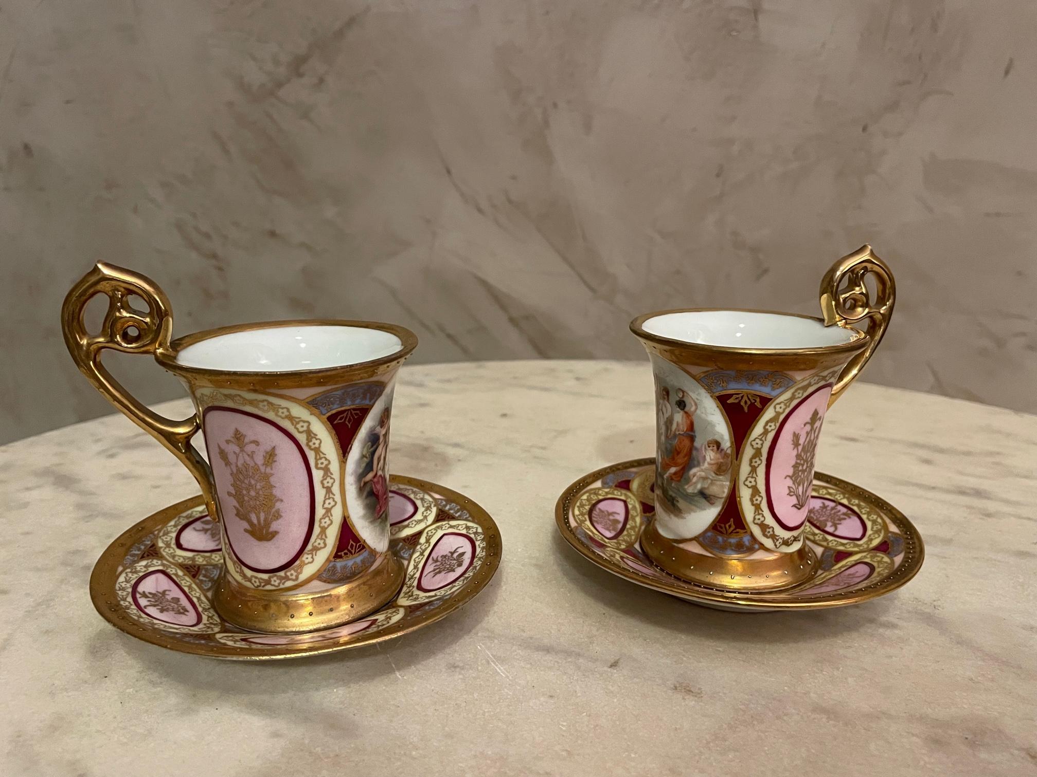 Beautiful set of two tea cups and saucers made by the Vienna porcelain manufacture. Pretty romantic decoration on each cup (both are different). 
Gilded with gold leaf details. Stamp of the Vienna porcelain. 
Very good condition.