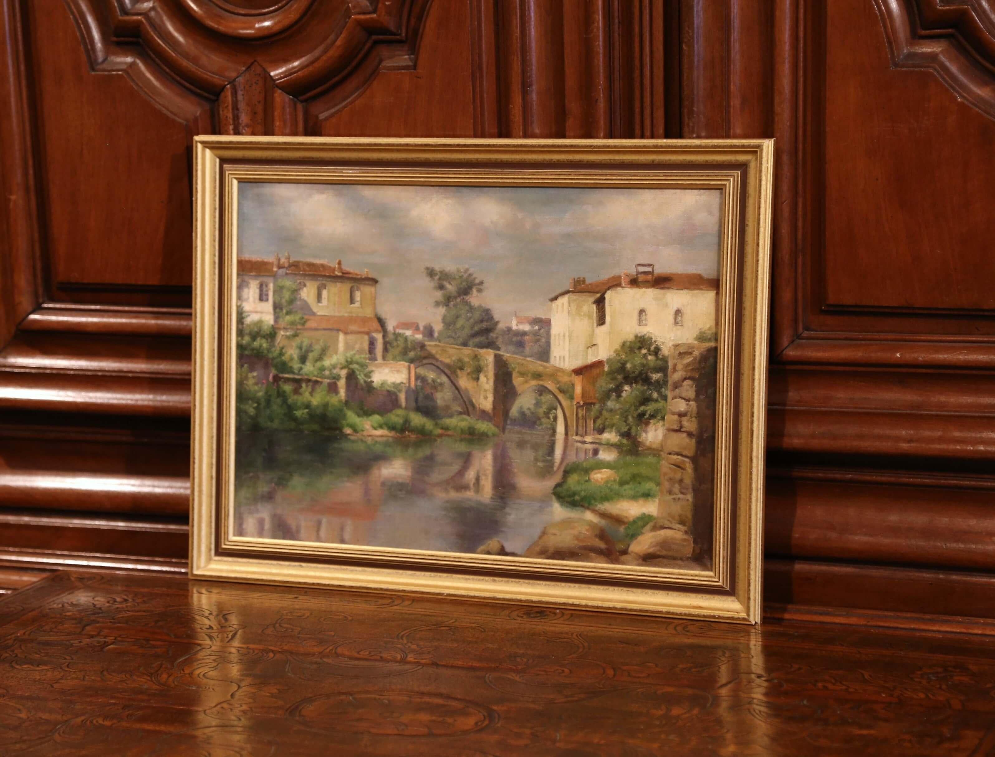 Set in a giltwood frame, the oil on canvas painting depicts a typical Provençal village with 