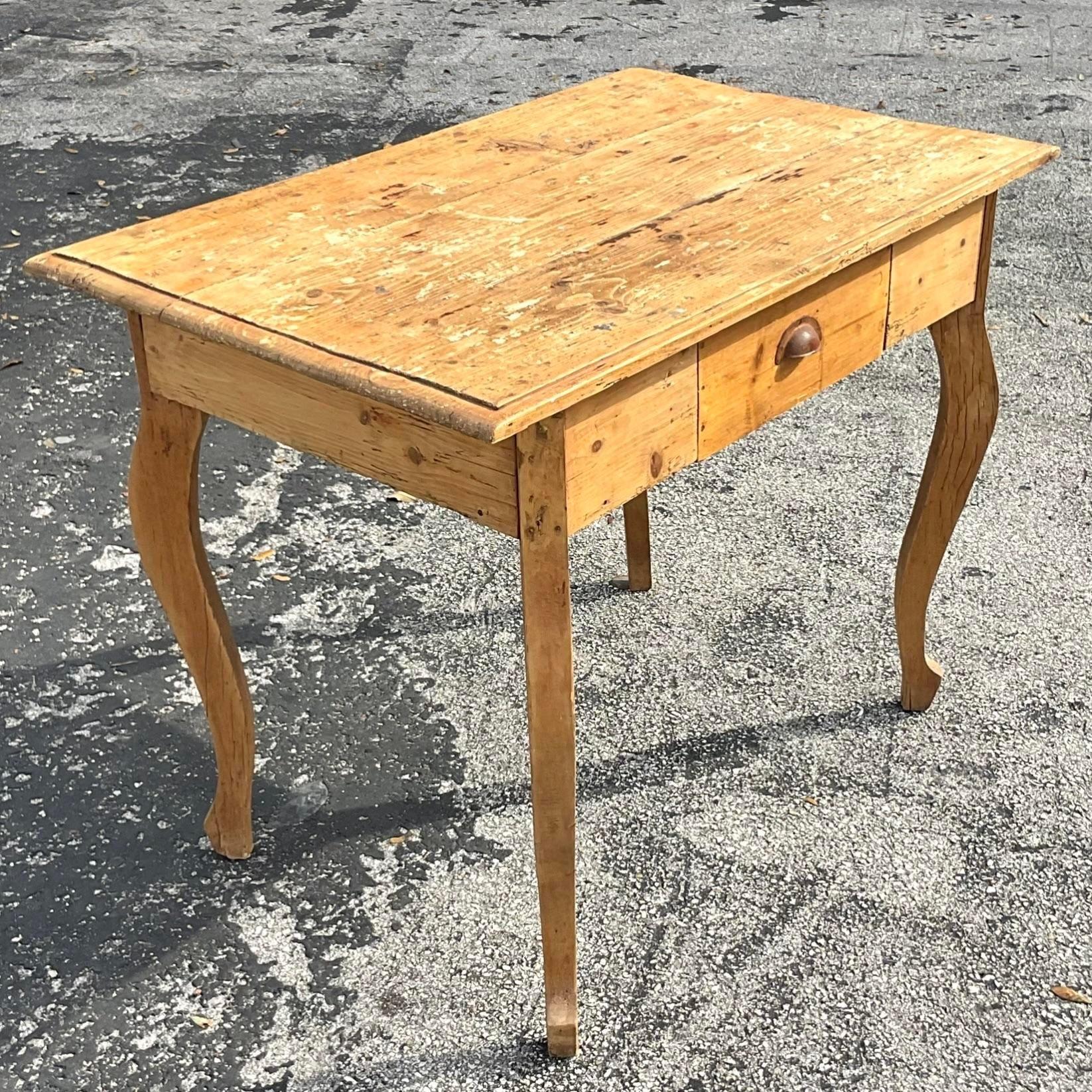 A stunning vintage Boho writing desk. Made in France and the perfect amount of patina from the years of use. Rustic Cabriolet legs and a clean shape. Acquired from a Palm Beach estate. 