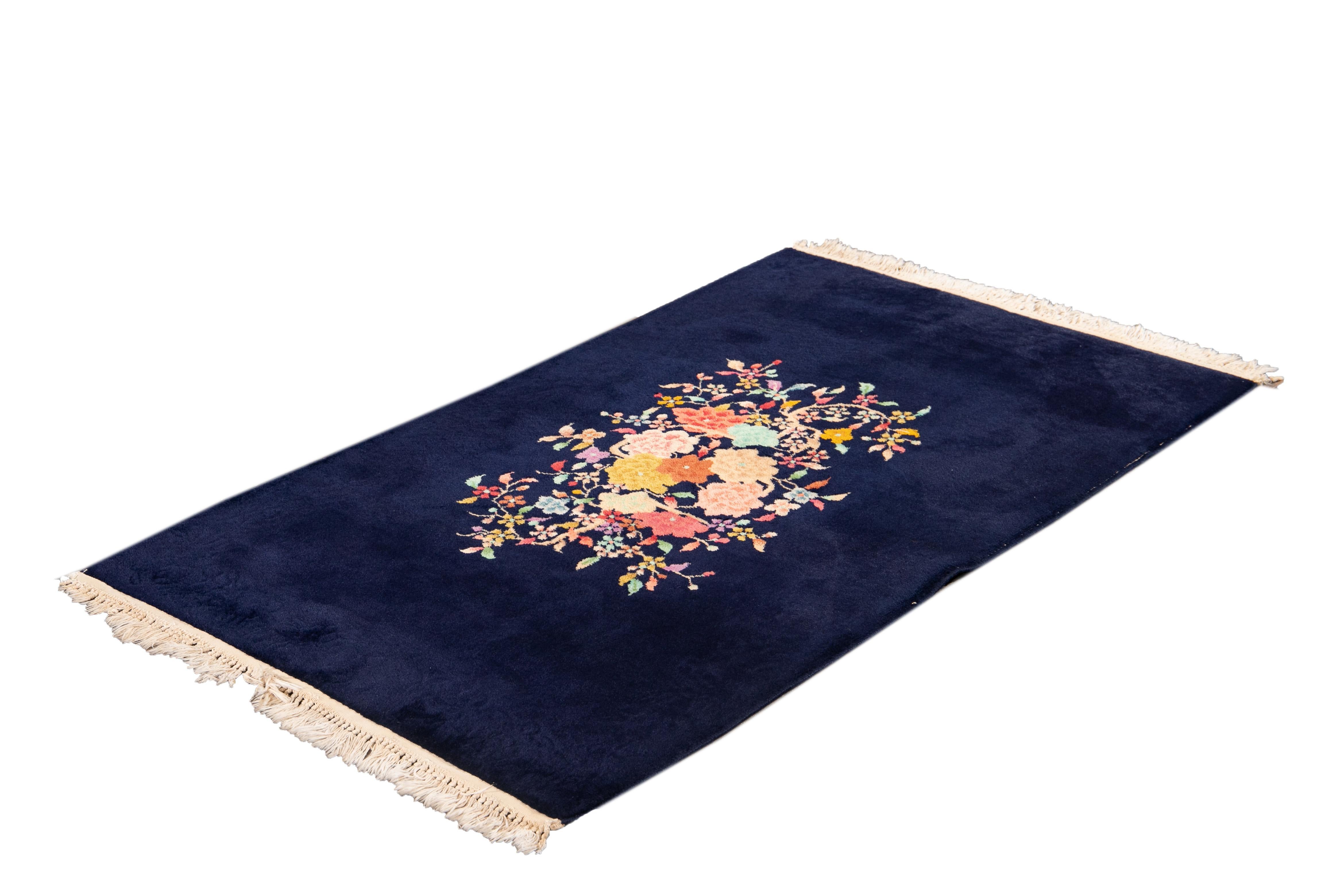 Beautiful antique Chinese Art Deco rug with a navy blue field and multicolored accents with a floral design in the center.

This rug measures 3' 0