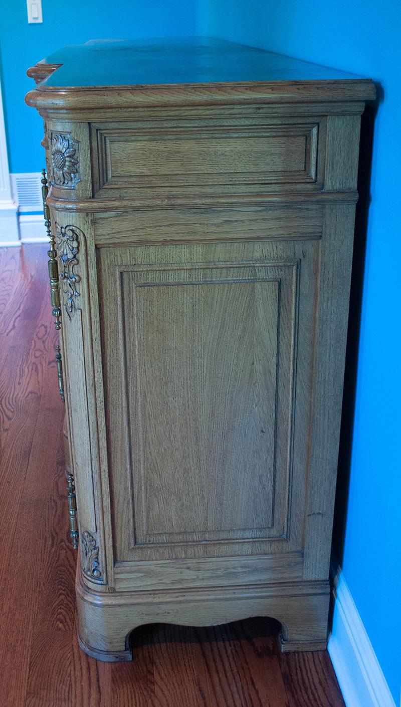 Large French oak console/server. Solid French oak from the Brittany region of France. Hand carved with beautiful detail from this region. The original brass hardware adds to this unique piece. It can be used under a TV in a bedroom or family room or