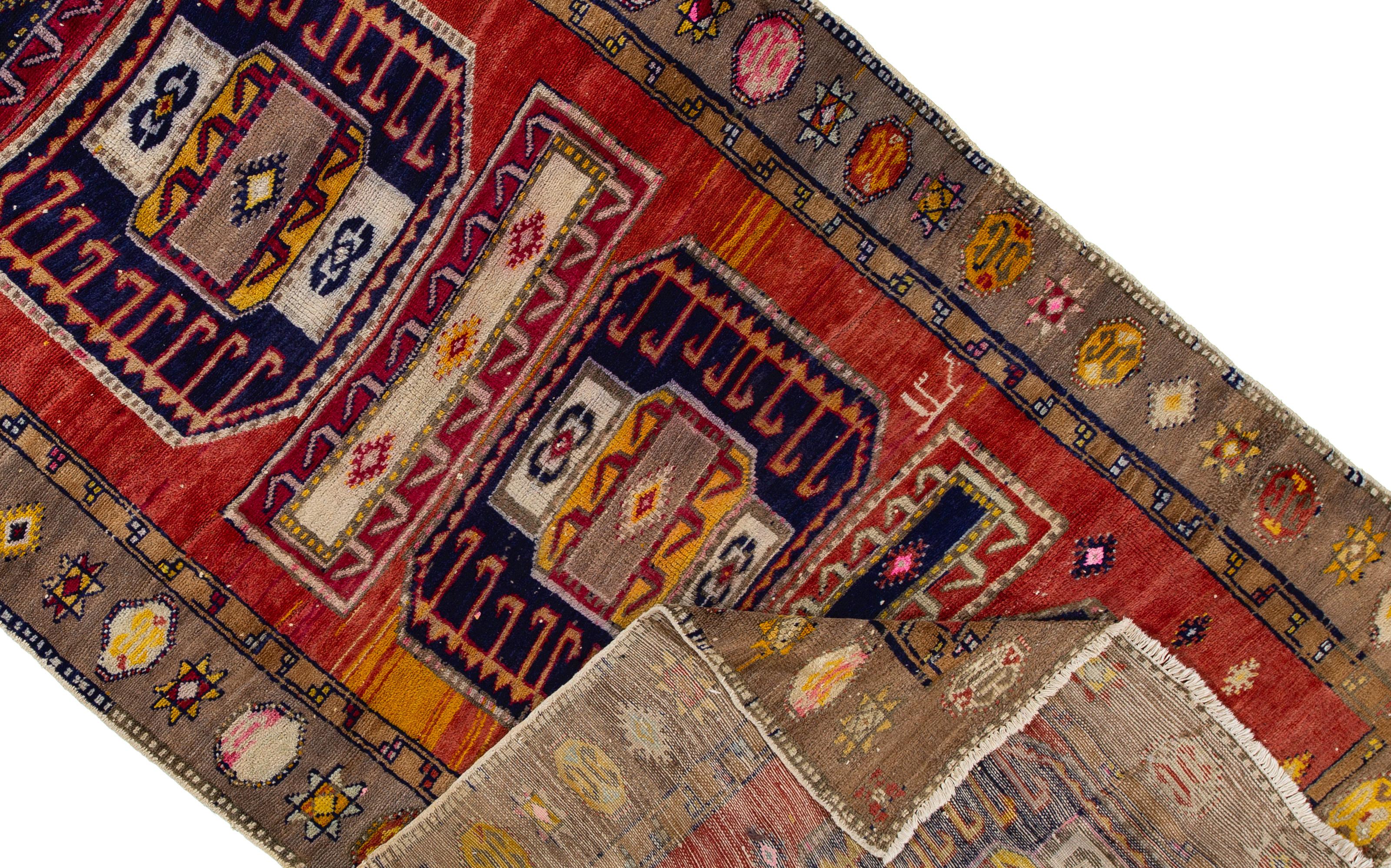 Beautiful Vintage Northwest Persian runner rug, hand-knotted wool with a red field and colorful accents with an all over geometric design.

This rug measures 5' 8