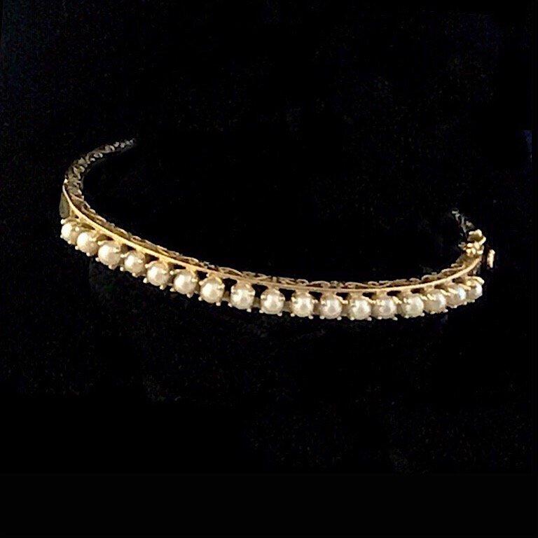 This pre-appraised 14k gold bangle-set bracelet has recently been appraised. It has 17 matched white 3mm cultured pearls. Per the appraisal it was made sometime between 1940-1970. It is a collector’s item. There is only one available. The condition