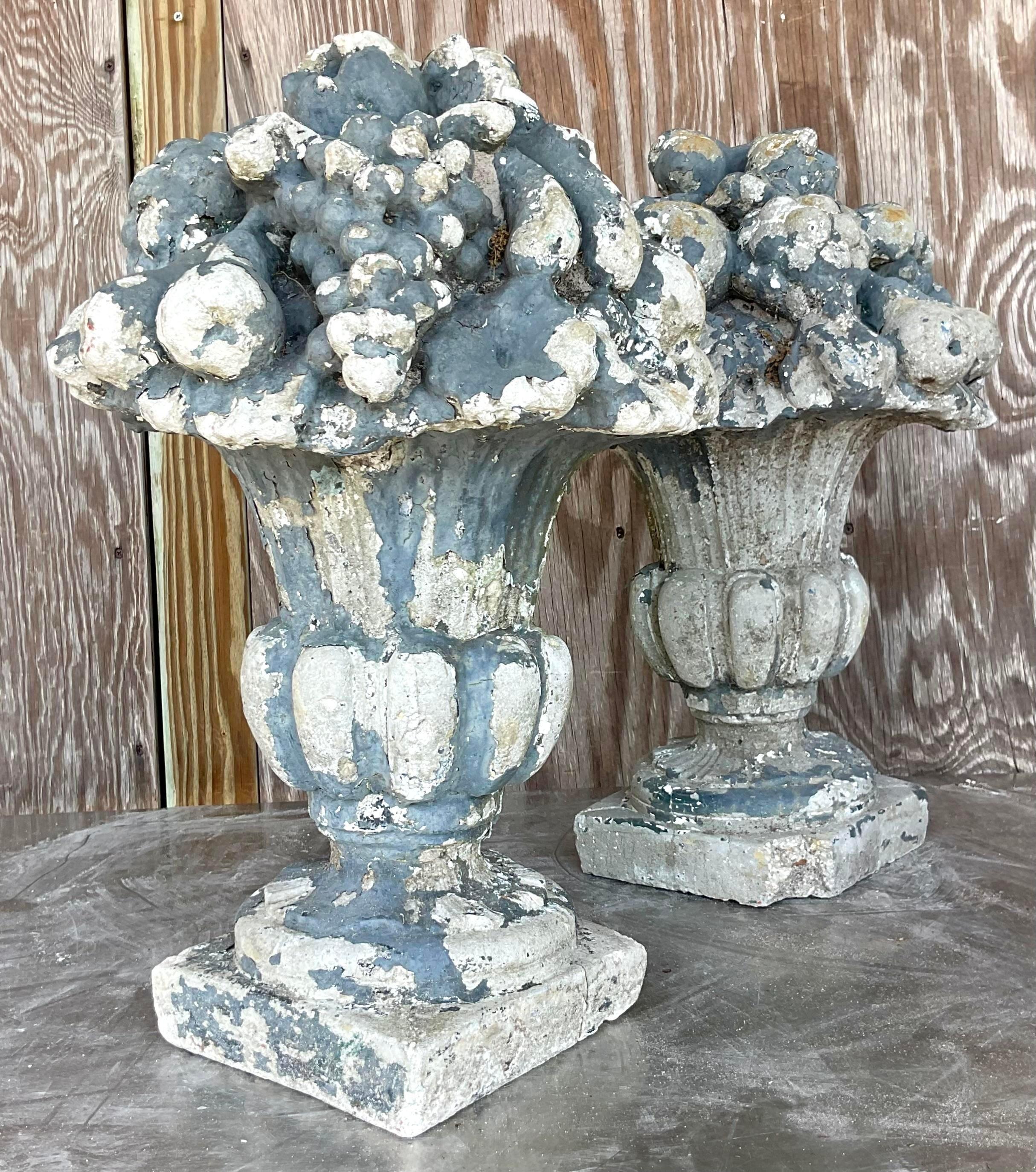 Embrace classic elegance with this pair of vintage Regency floral arrangements, crafted from patinated cast concrete. Each piece exudes a sense of enduring beauty and sophistication, reminiscent of timeless American design. Perfect for adding a