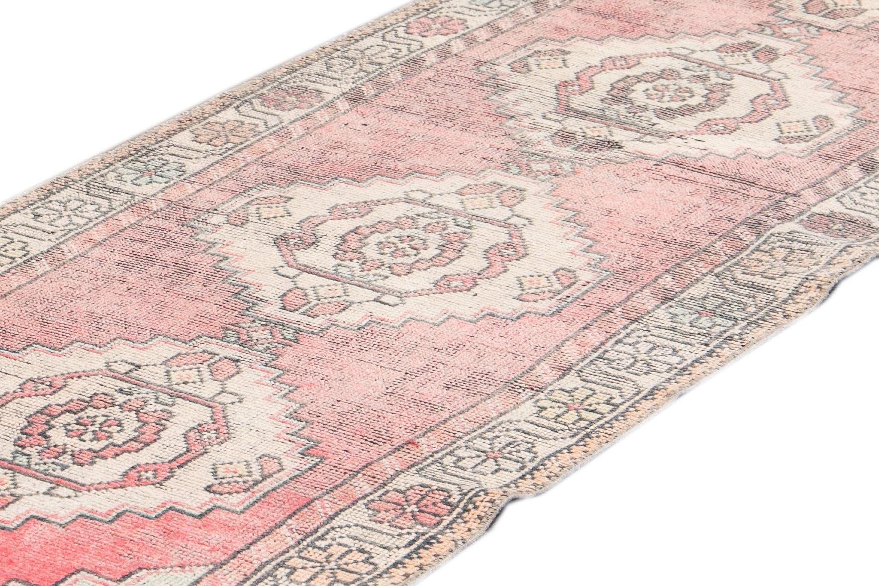 Beautiful Antique Runner rug, hand knotted wool with a light pink field, ivory and gray accents in an all-over multi medallion geometric design.

This rug measures 2' 10