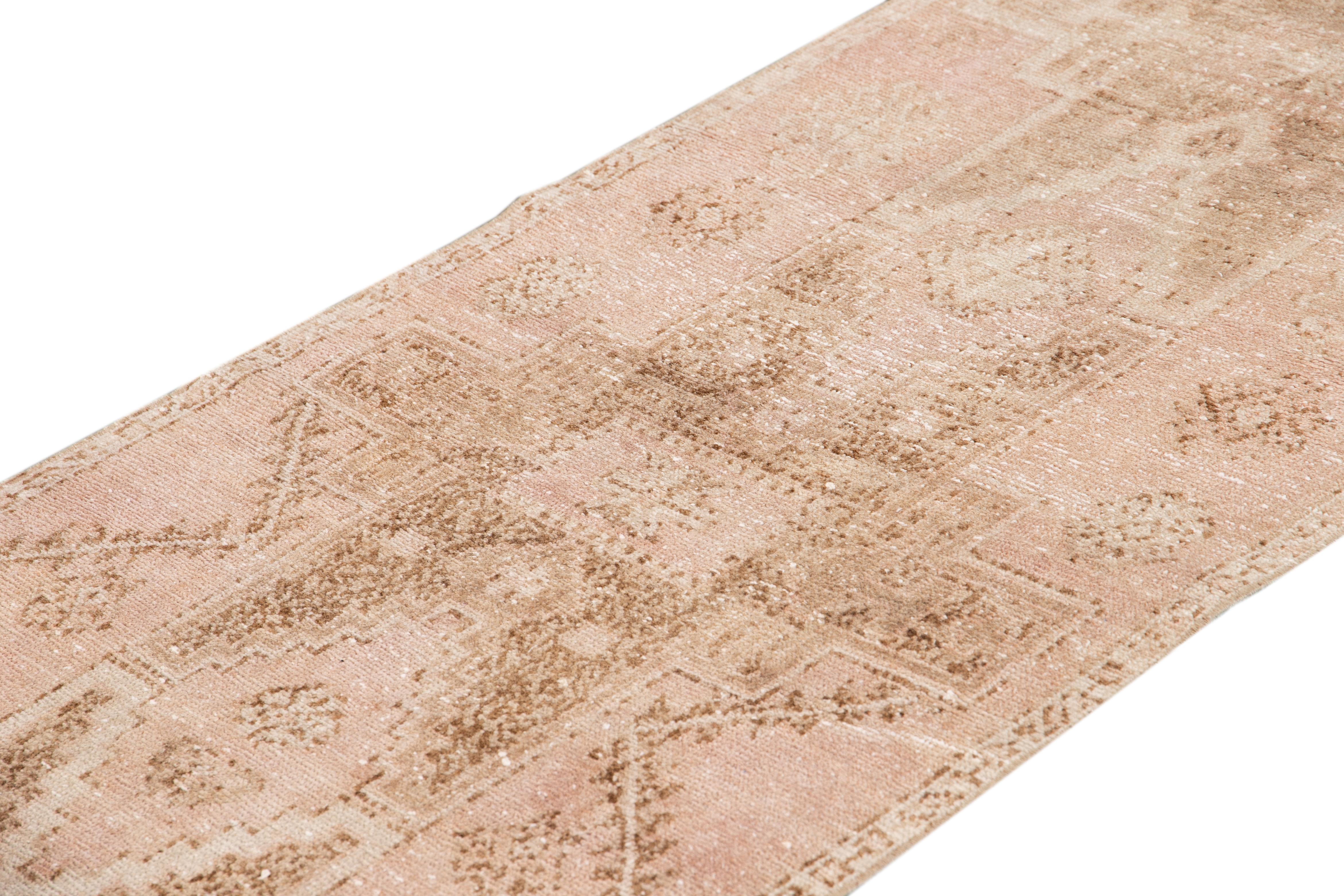 Beautiful antique runner rugs, hand knotted wool with a blush field, tan and light brown accents in an all-over multi medallion geometric design.

This rug measures 2' 9