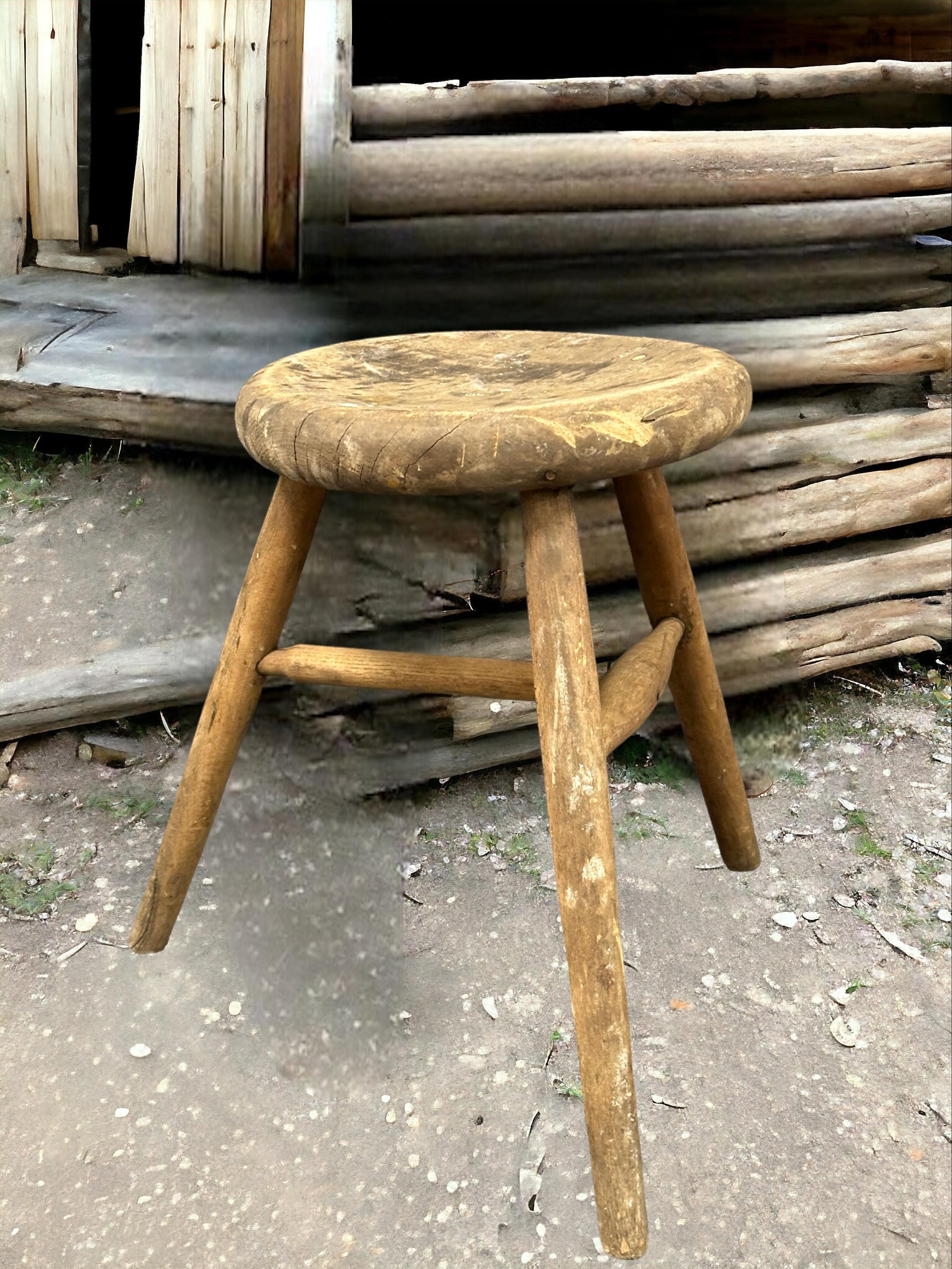This early 20th century wabi sabi 3 leg workshop stool from Germany is an excellent example of this style. The piece has a square, rustic-looking seat made of wood and is supported by three spindle legs. The stool has a simple, understated design