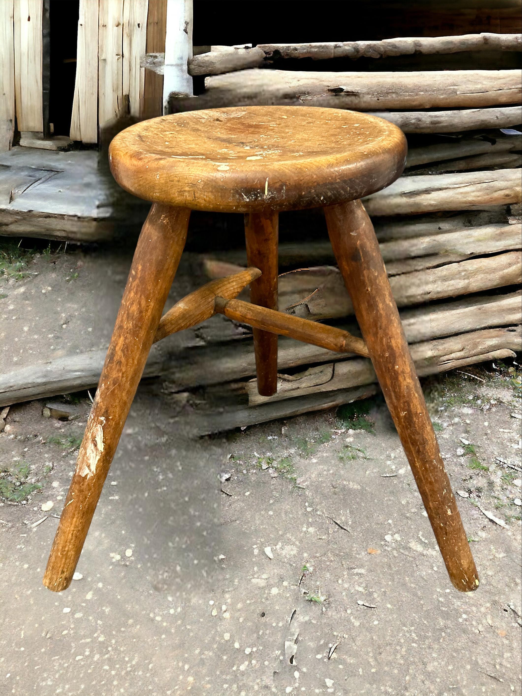 This early 20th century wabi sabi 3 leg workshop stool from Germany is an excellent example of this style. The piece has a square, rustic-looking seat made of wood and is supported by three spindle legs. The stool has a simple, understated design