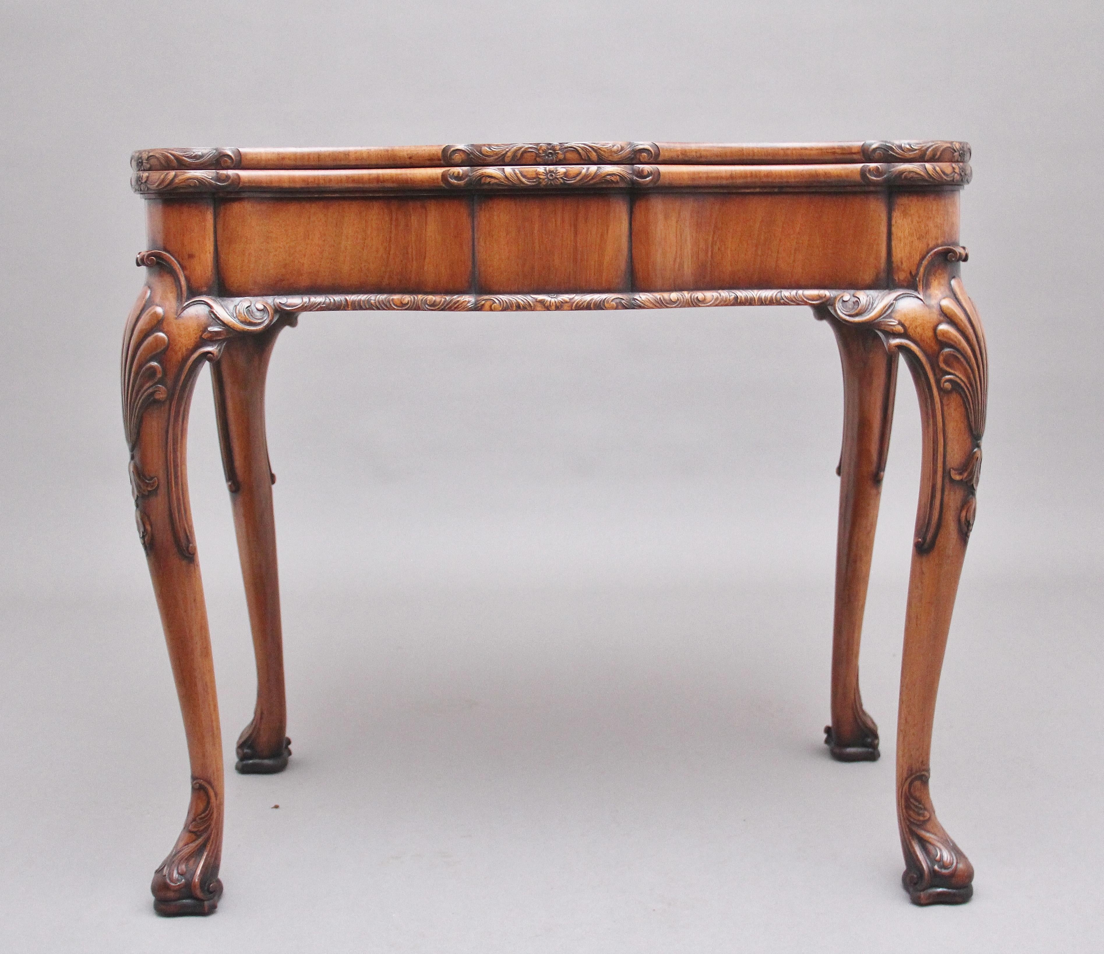A superb quality early 20th century walnut card table, the shaped hinged fold over top having a lovely figuration with carved floral decoration on the edge, folding over to reveal green baize playing surface, having a deep frieze below with further