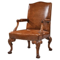 Fauteuil en noyer sculpté avec tissu d'ameublement en cuir, début du XXe siècle