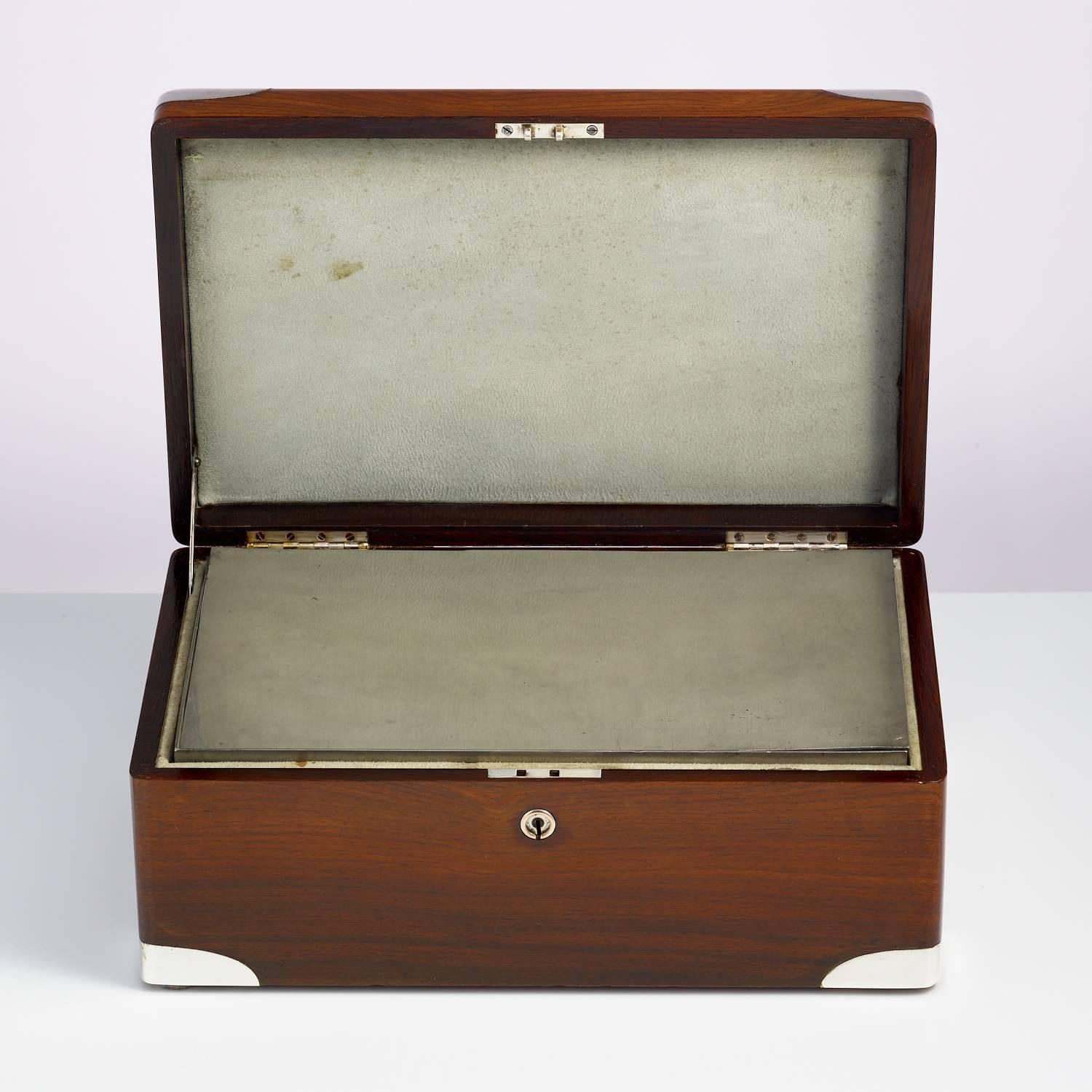 An early 20th century walnut cigar Humidor, circa 1900 with sterling silver corners and nameplate.
This piece has a campaign feel the corners are perfectly moulded.
The walls of the box have a inner insulation felt. There is a separate zinc alloy