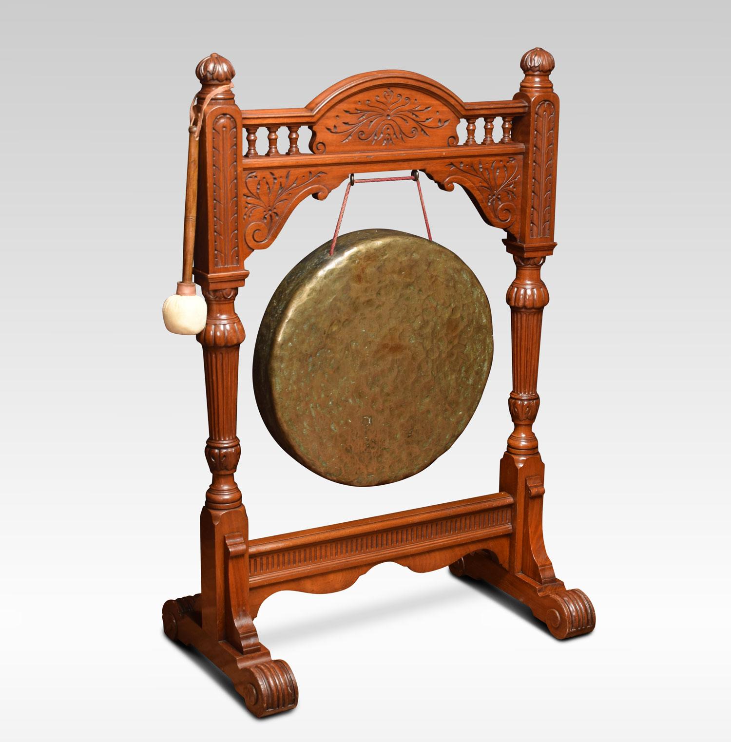 Large carved walnut dinner gong, the frame with scroll and leaf carved decoration. Flanked by carved fluted uprights. All raised up on trestle base, with striker.
Dimensions:
Height 42 Inches
Width 27 Inches
Depth 16 Inches.