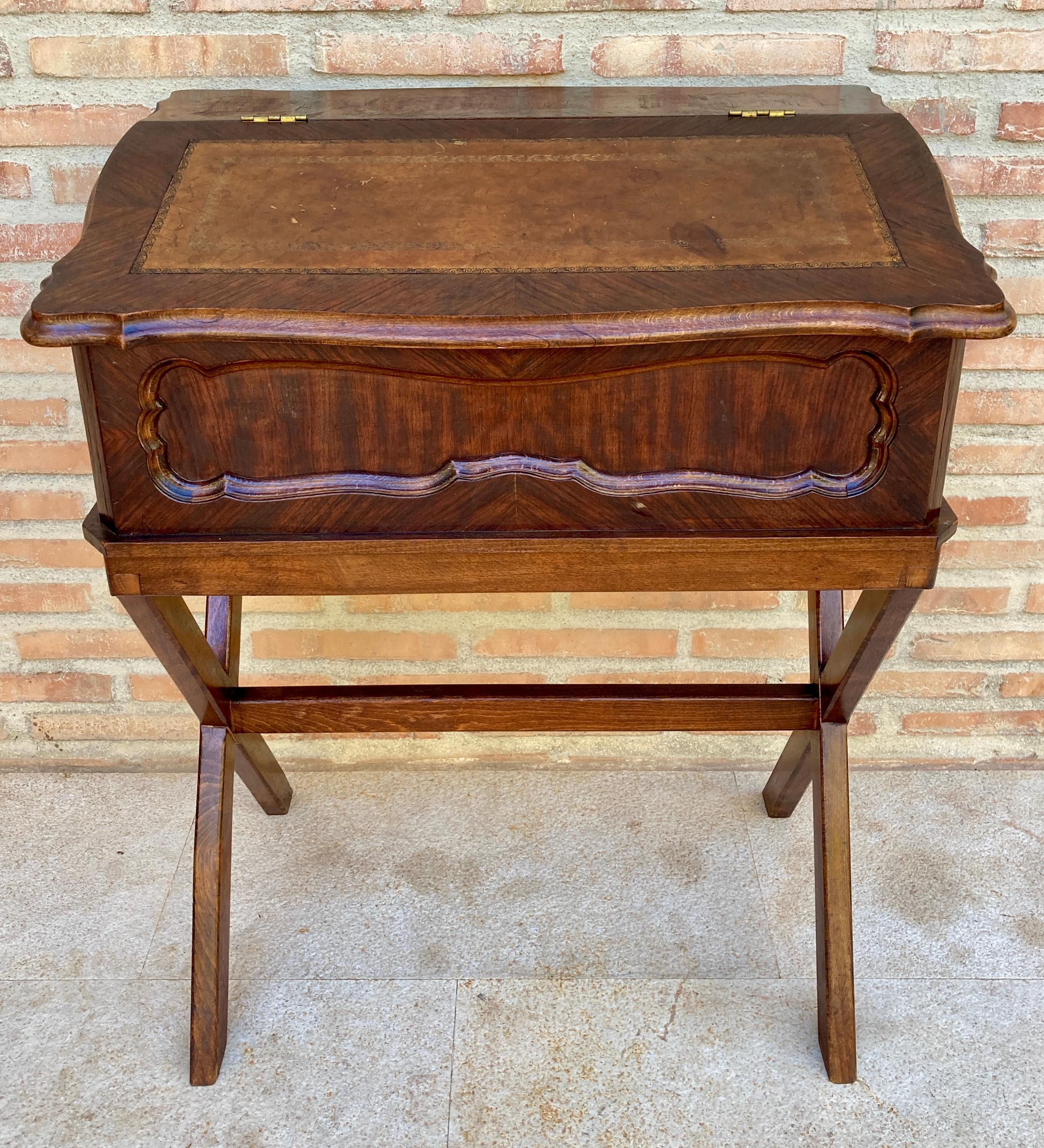 The early 20th century French secretaire was made of walnut. 
Called secretaire en abbatant by the French, in reference to the sloping-front drop-down desk surface, this particular example features the classic leather writing mat in glorious relief