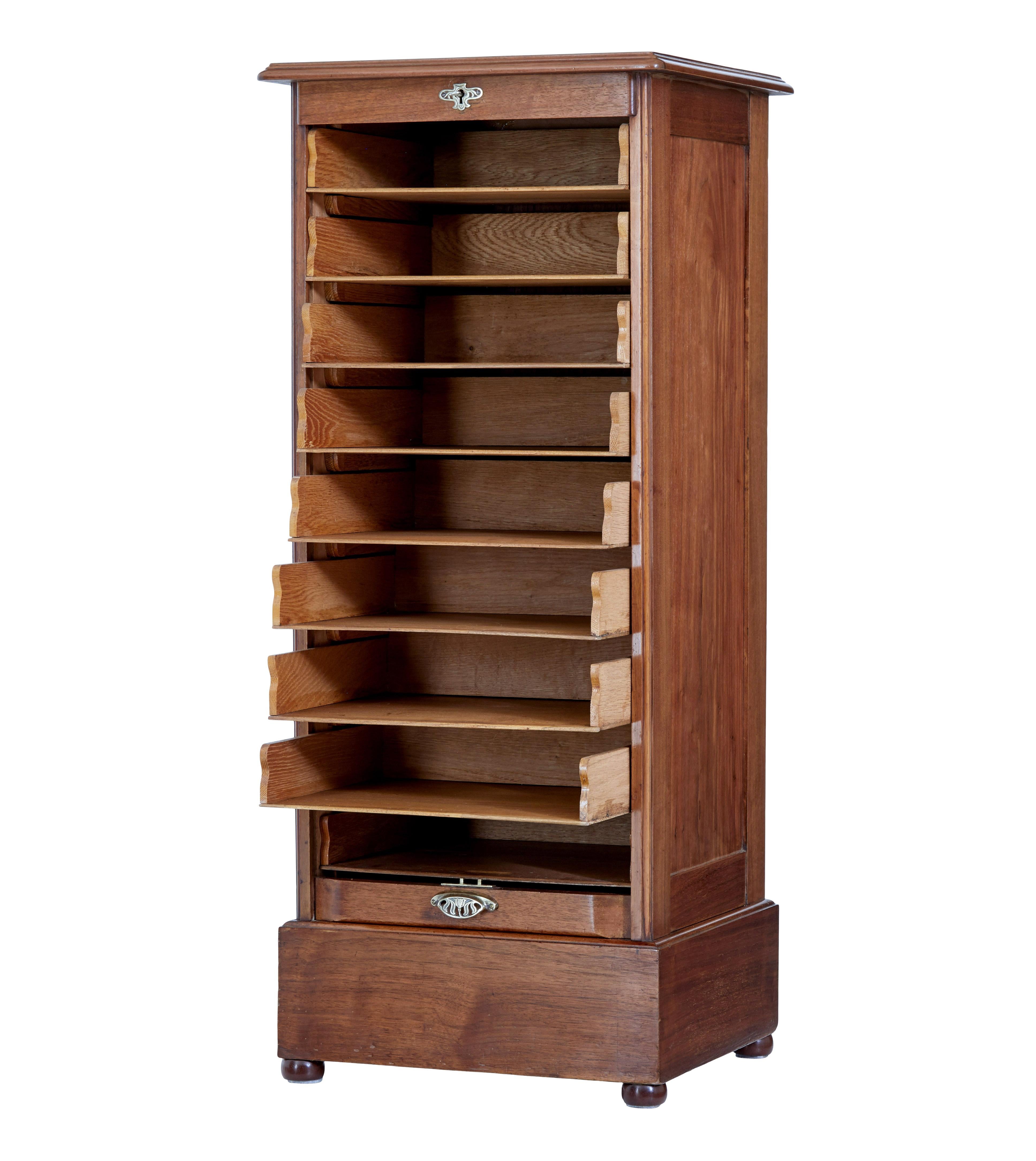 Early 20th century walnut tambour cabinet circa 1910.

Good quality tambour fronted drawer cabinet. These cabinets are usually made in oak and mahogany but this one is made in walnut.

Typical piece that would have been found in an edwardian office