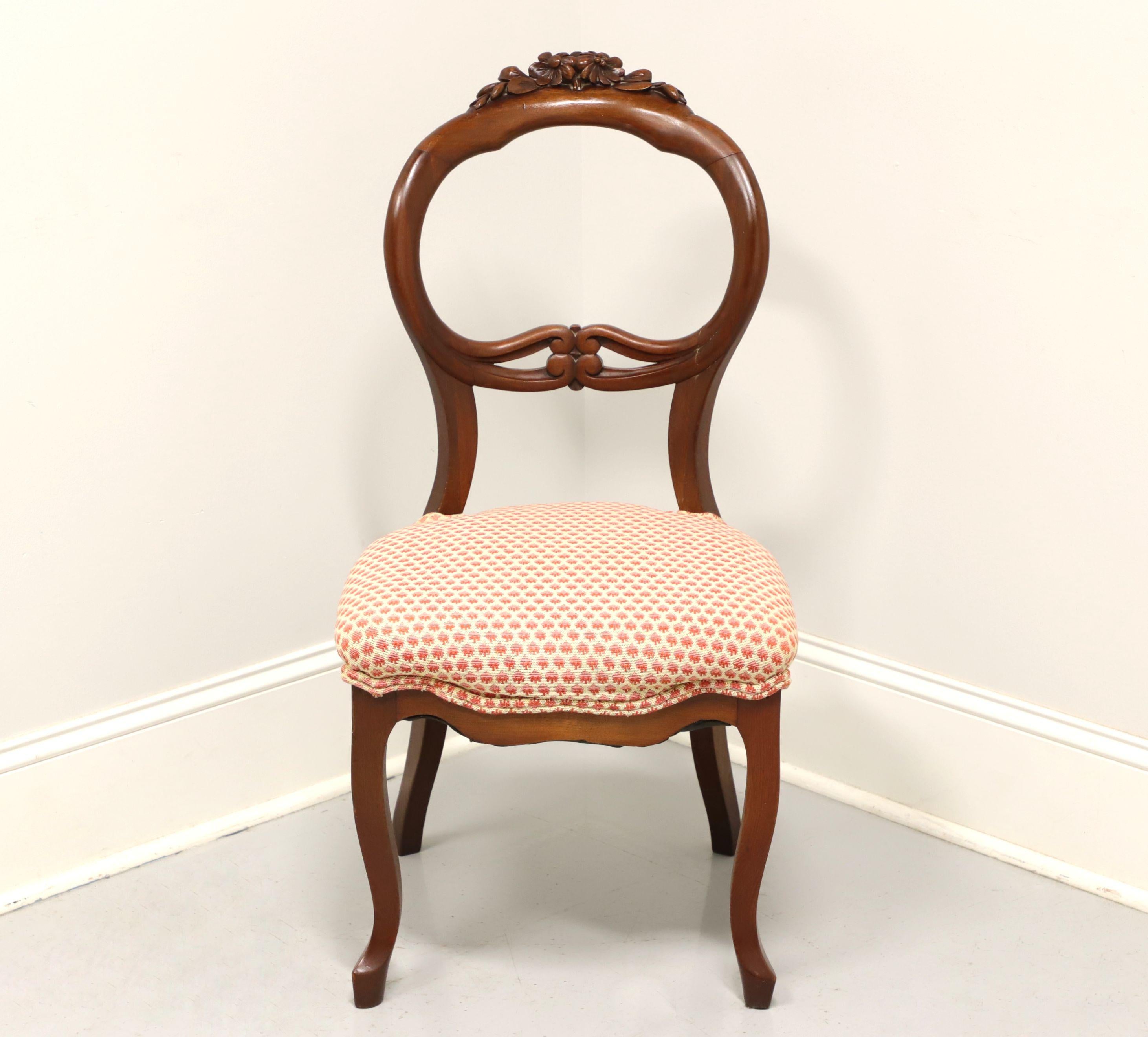 An antique Victorian balloon back side chair, unbranded. Walnut with decorative floral carving to crest rail, carved backrest, salmon colored raised dot fabric upholstered seat and cabriole legs. Likely made in the USA, in the early 20th