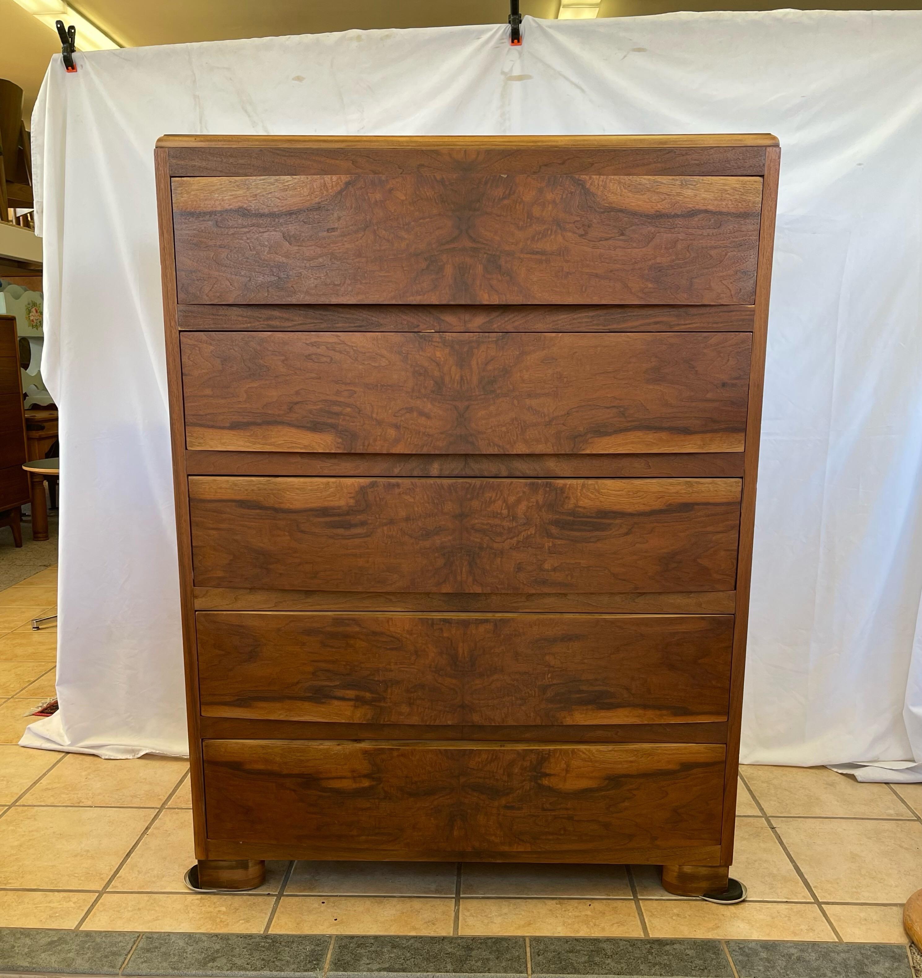 Rare and beautiful Art Deco walnut Burl dresser with soft bow front. There are five drawers with hidden side pulls. Solid wood drawer liners and dovetail construction.

Dimensions: 36W 21D 49H.
