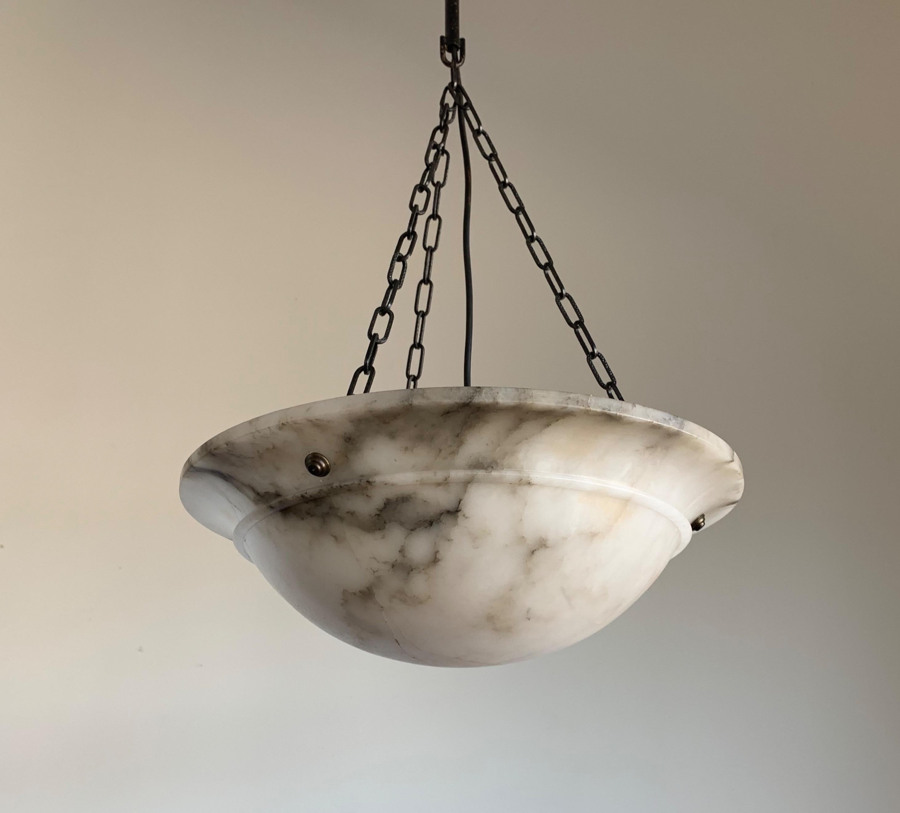 Beautiful design mineral stone pendant.

If you are looking for an excellent condition and practical size Art Deco light fixture then this fine specimen with its beautifully flowing black veins in the shade could be perfect for you. The shape of