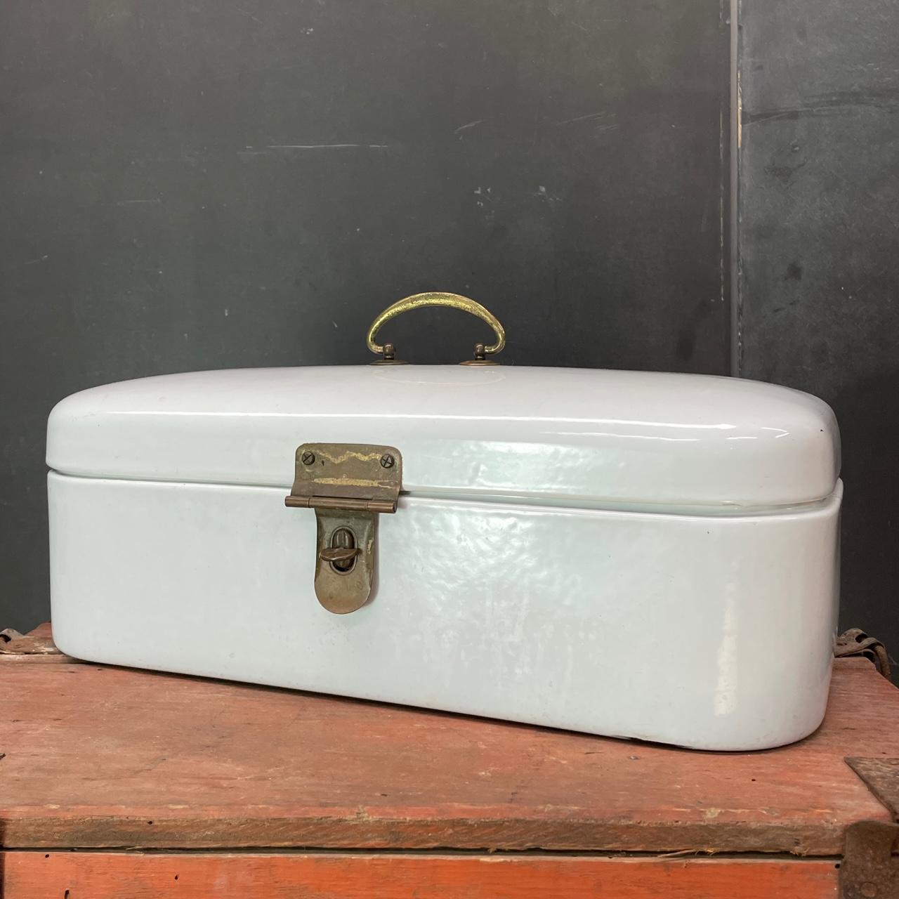 A very nice clean enamel lidded storage box with tarnished brass hardware. A wonderful design element for a Coastal or Colonial Revival interior. Good size for storage, small books, or remotes. Latch is not foolproof, so be careful carrying it about