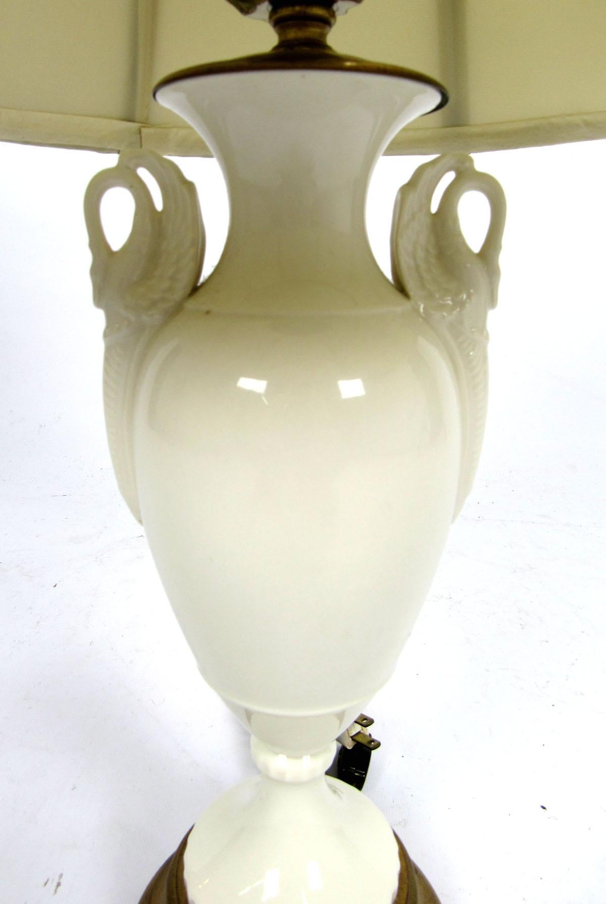 White porcelain lamp by Lenox with swans on the neck and gold trim.