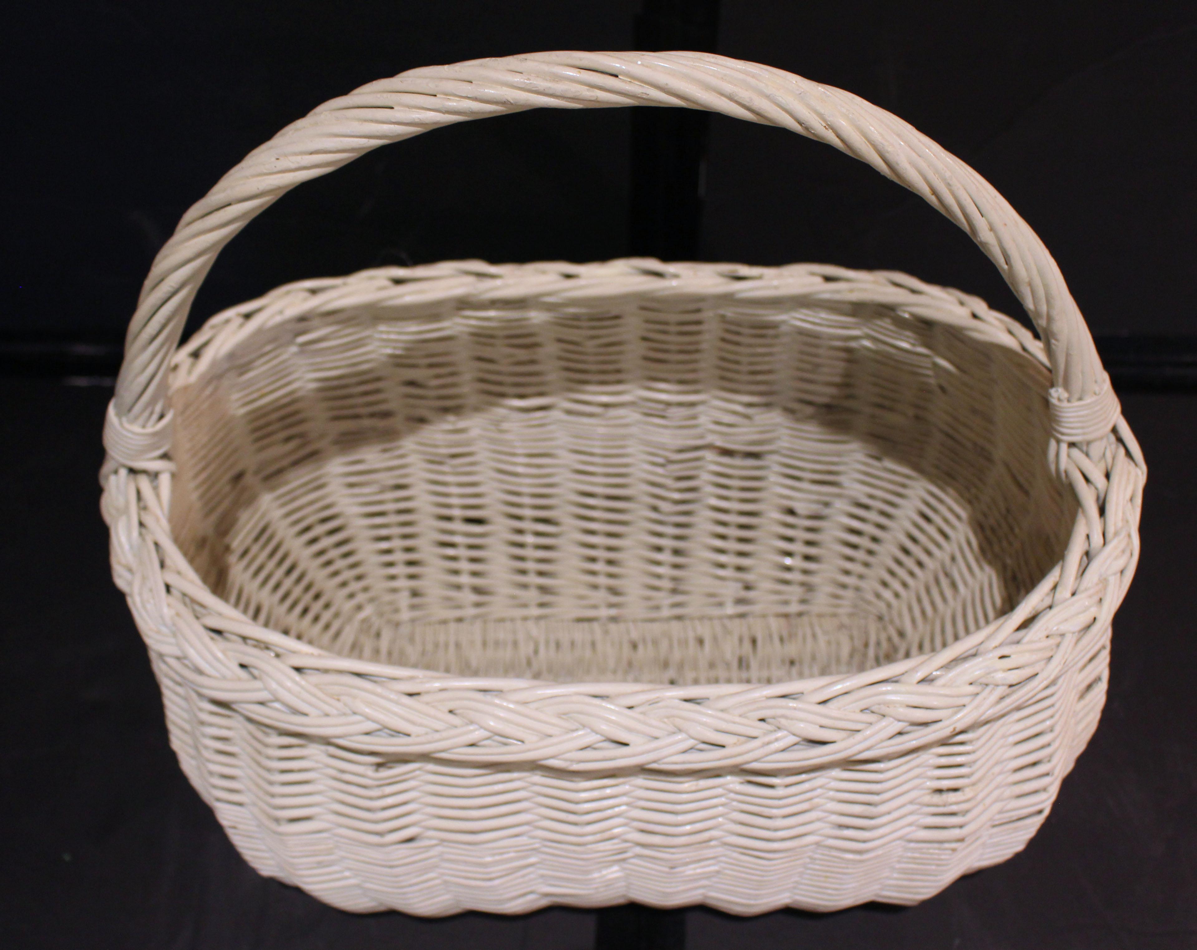 Early 20th century wicker handled basket, New England. Woven wicker market basket with twisted integral handle - ideal for many uses! Repainted in cream color.
18