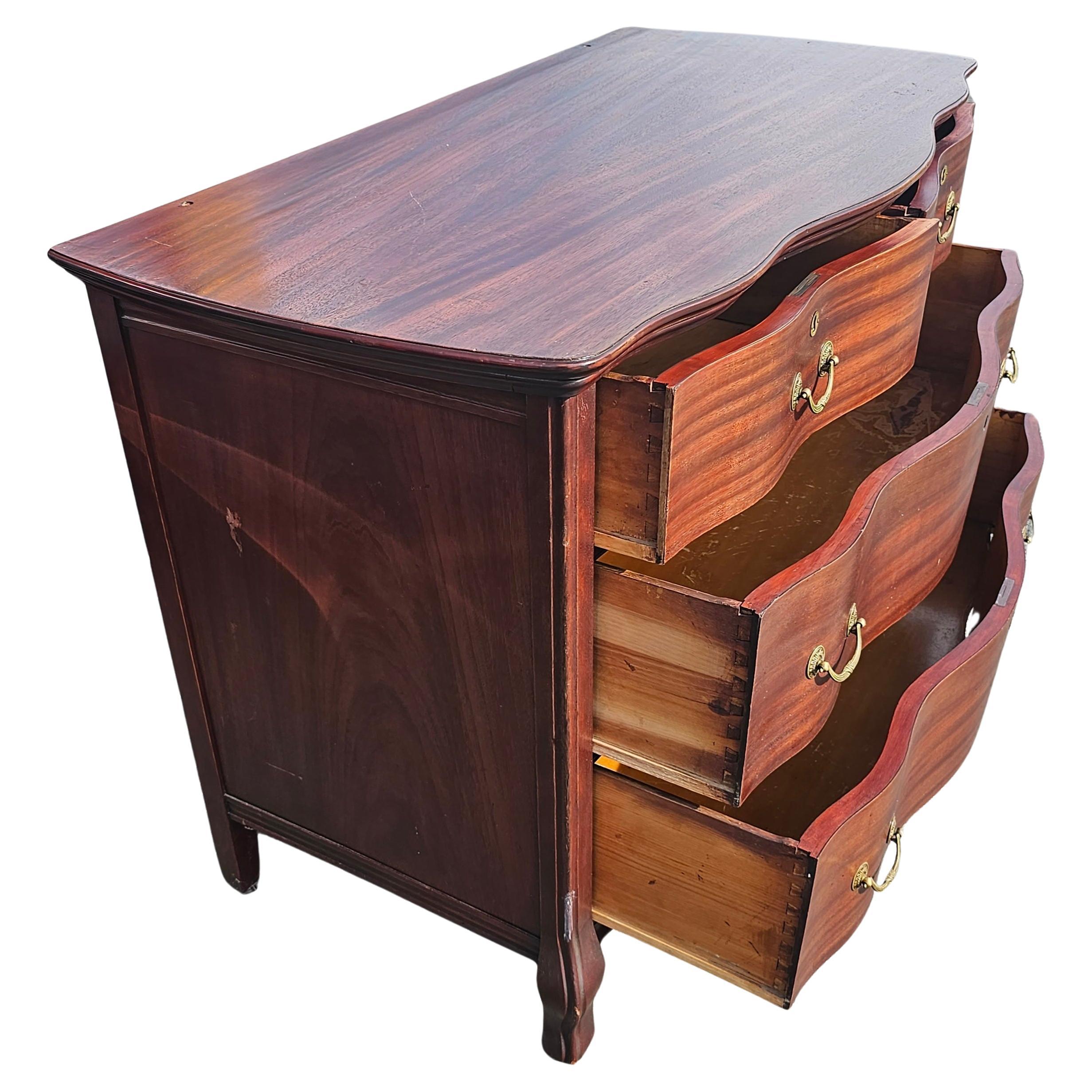 American Early 20th Century Widdicomd Tiger Mahogany Serpentine Commode Chest on Wheels For Sale