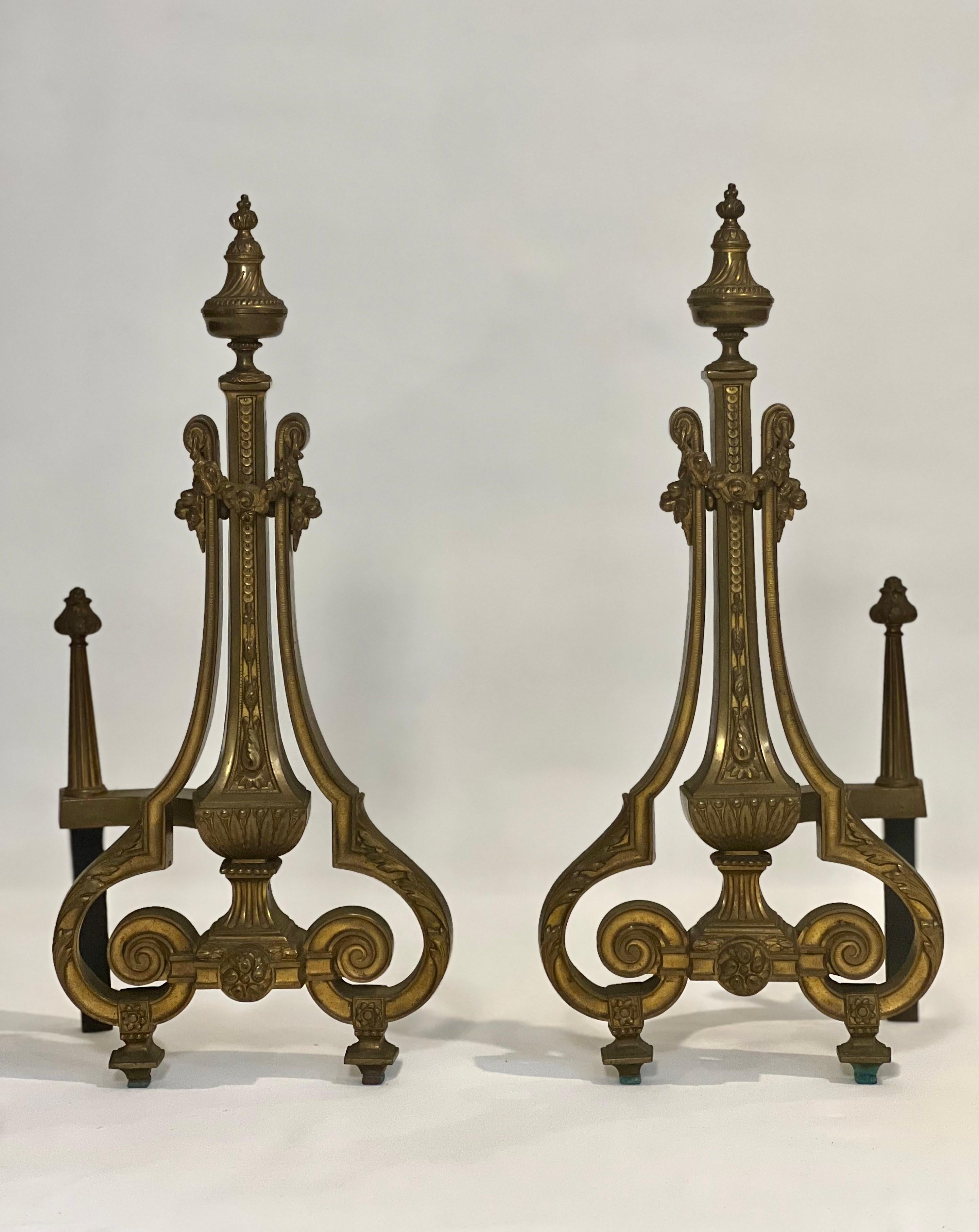 Neoclassical French Empire style gilt brass andirons by William H. Jackson Company, early 20th century.

Incredibly detailed pair from the finials down to the feet featuring floral and foliate motifs. Beautifully shaped with a well-balanced form and