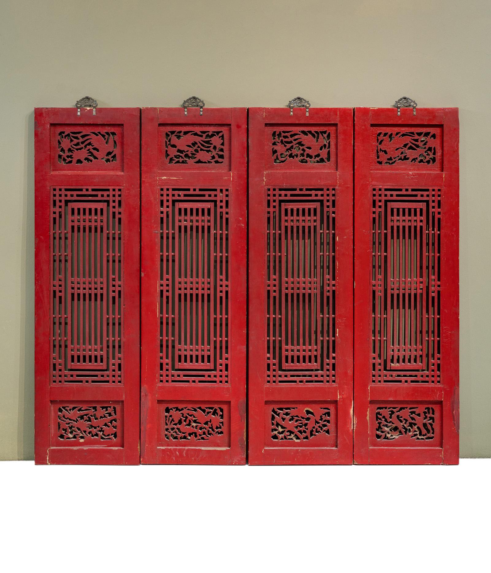 A set of 4 window panels from Fujian province, China. The original hinges have been removed and patched, and new hangers have been added on top, however overall the colours are largely untouched. The small section across the top has carvings of