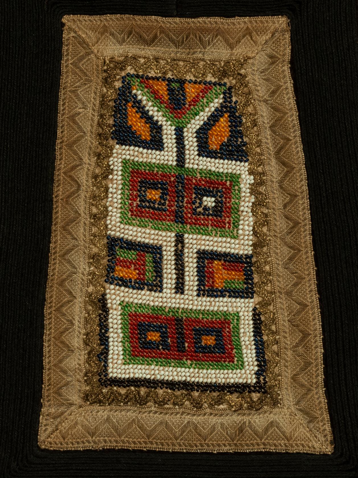 Woman’s apron
Sarakatsani culture, Greece
Wool glass beads,cotton, silk
Early 20th century
16.5 by 15 inches (42 by 38 cm)

An apron, podia, traditionally worn by married women of the Sarakatsani, a formerly nomadic tribe of northern Greece.  The