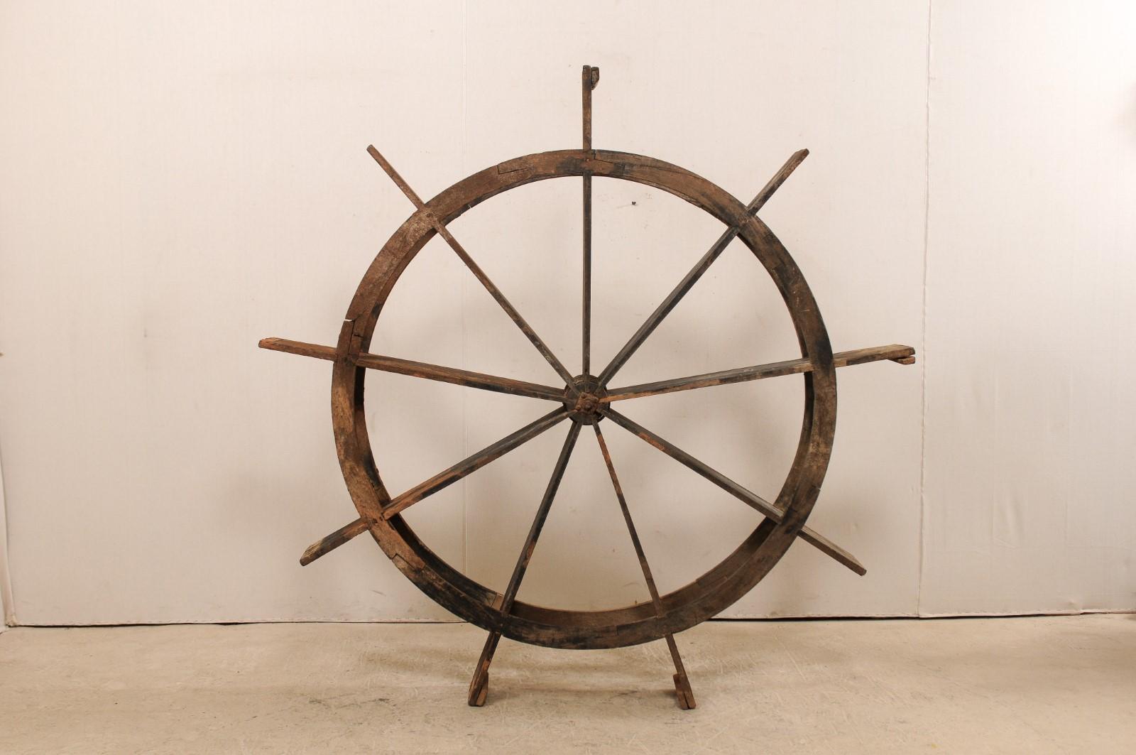 A large antique water wheel from Kerala, India. This Kerala water wheel which stands approximately 6.75 ft tall, also known as a 