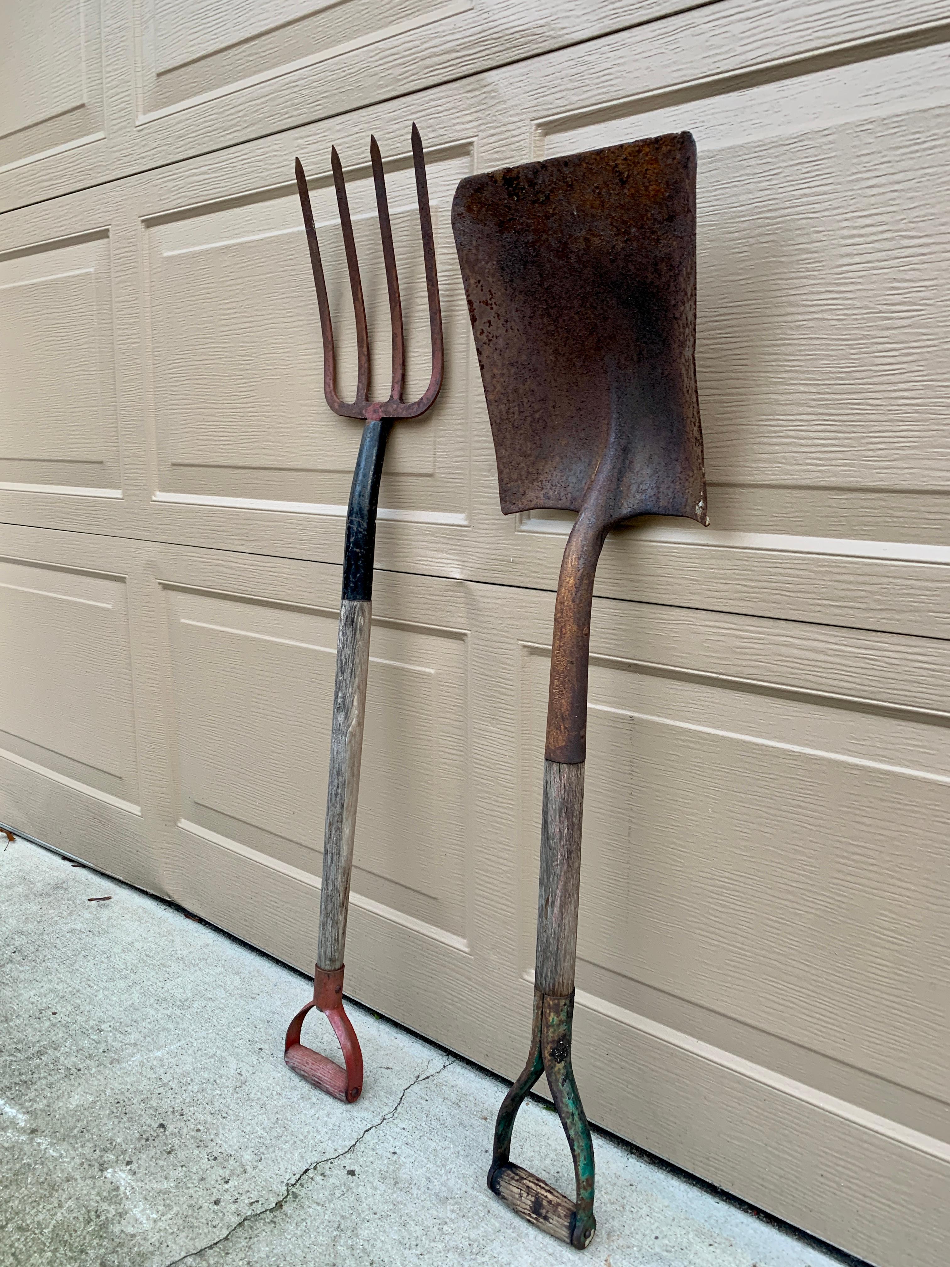 A beautiful pair of antique wooden & iron hand made garden tools consisting of a hay fork and a shovel. These would be ideal for an installation on a wall on custom wall mounts. The rustic patina and farmhouse style would add charm to any country