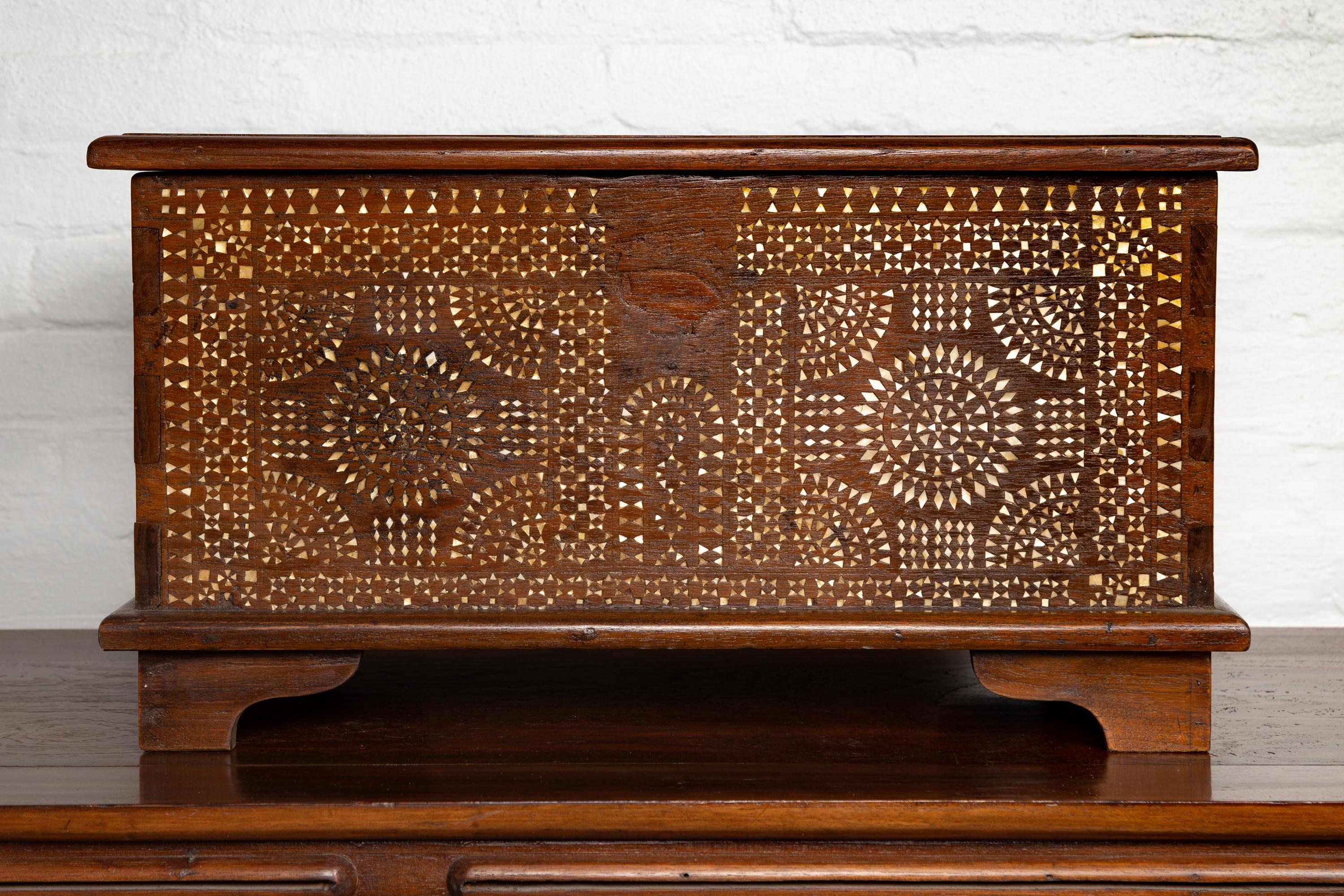 An antique Philippine early 20th century small wooden blanket chest from Mindanao with mother of pearl inlay. Born on the island of Mindanao in the Philippines during the early years of the 20th century, this lovely blanket chest captures our