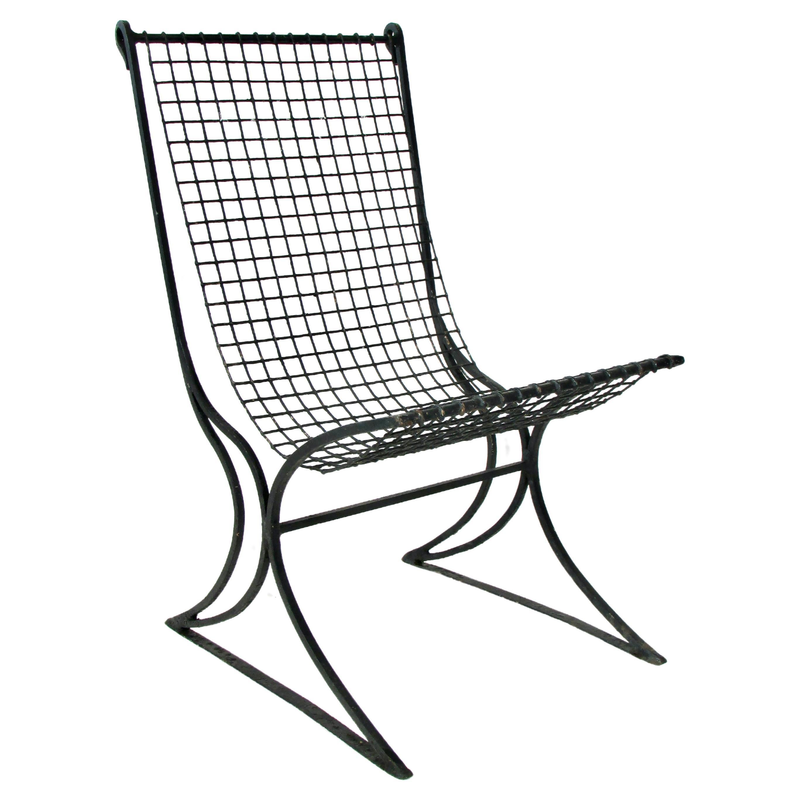 Early 20th century wrought iron with wire seat garden chair in old black paint For Sale