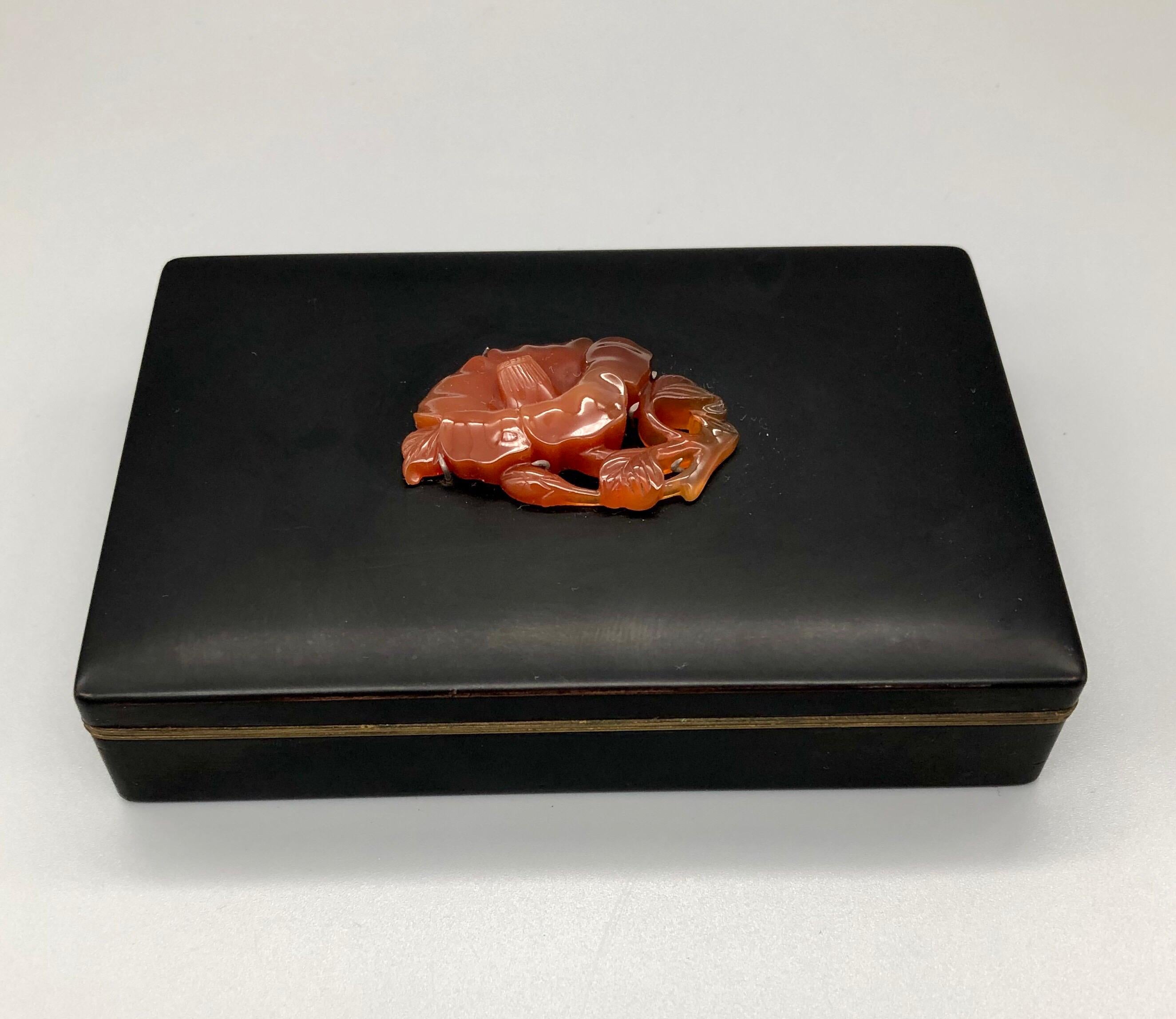 Lovely Classic Yamanaka black enamel box with their signature carved agate flower decorating the lid. Art Deco chic, with Japanese Minimalist sensibility.

The inside of the box is gilt, with Yamanaka and Made in Japan stamped on the bottom. There