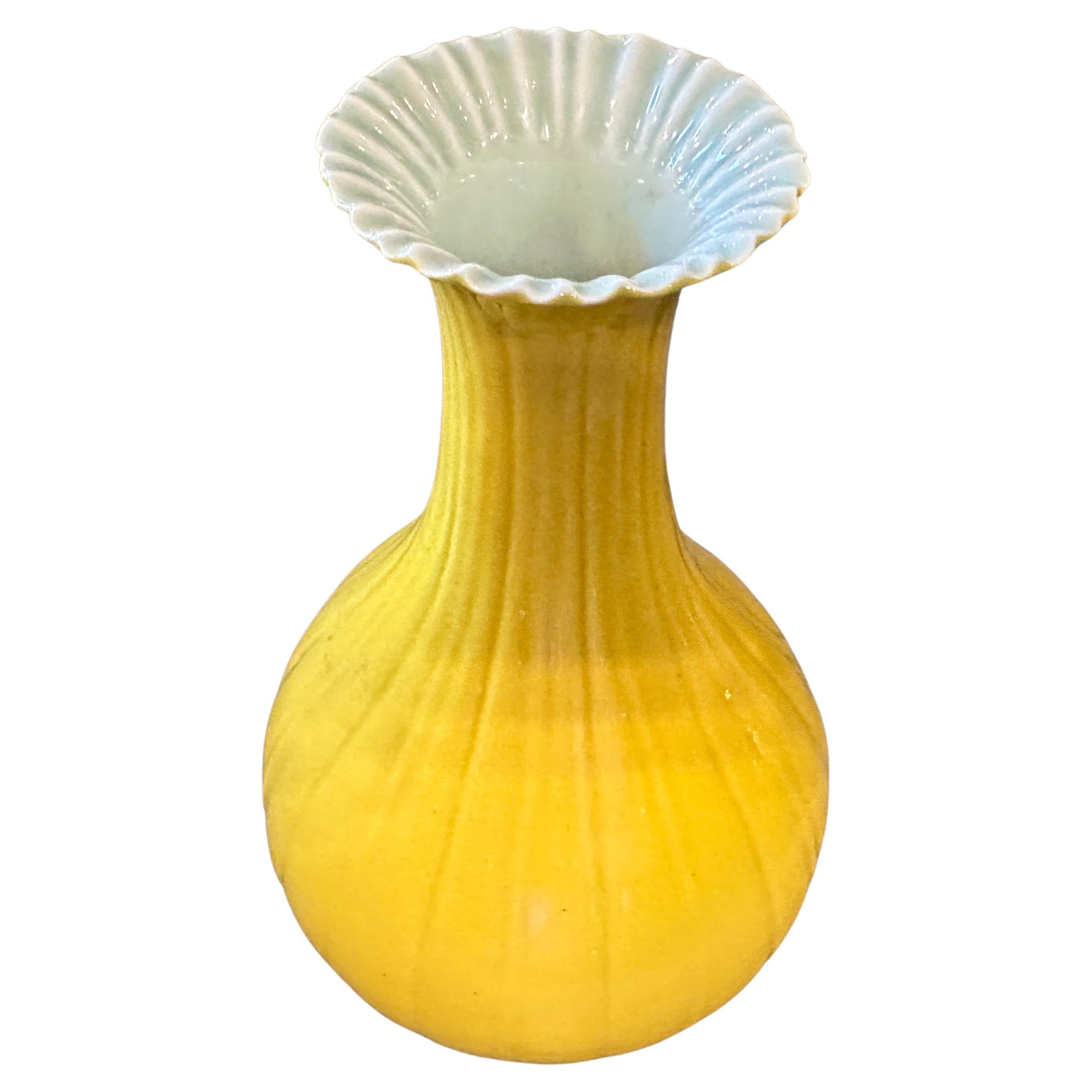 A perfect conditions yellow glazed porcelain vase manufactured in China in the early 20th century. It showcases exquisite craftsmanship and attention to detail. The vibrant yellow glaze covers the entire vase, giving it a captivating and lustrous
