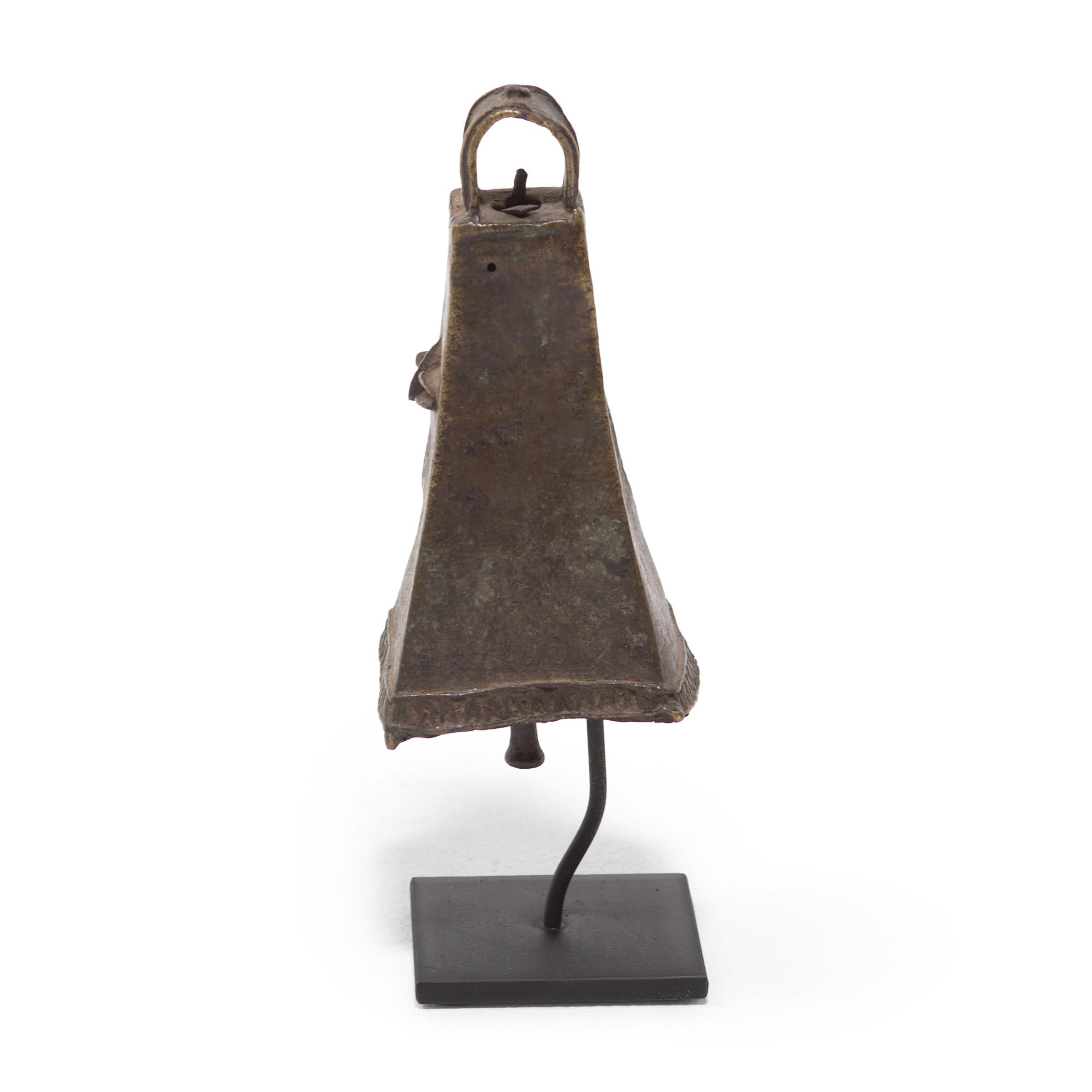 This four-sided brass face bell, known as omo, was created by an artisan of the Ijebu Yoruba People of Southern Nigeria. A mark of the wearer's rank and power, the bell would have been displayed by a prominent chief, worn at the left hip by a long