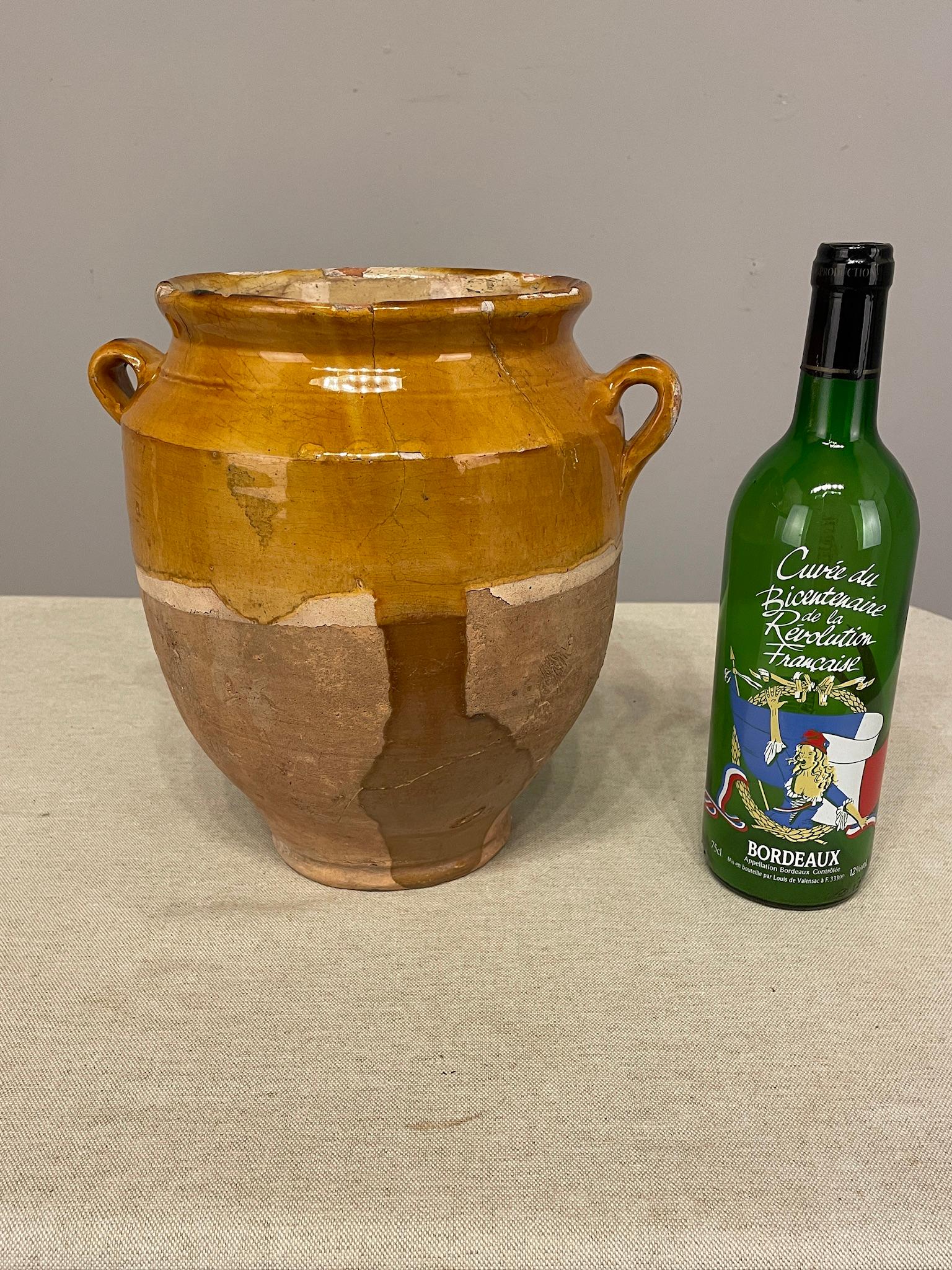 An earthenware confit pot from the Southwest of France with traditional yellow, ochre glaze with green drips. Minor chips and losses to glaze. These ordinary earthenware vessels were once used daily in the French country home and have beautiful
