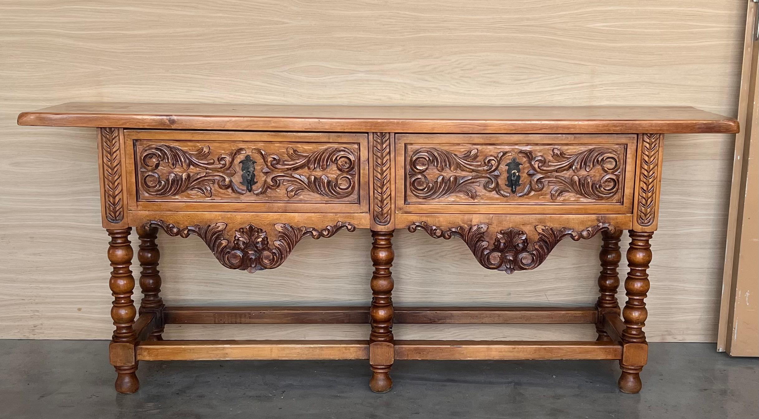 Console table made of carved walnut with turned legs and heavy top. 
