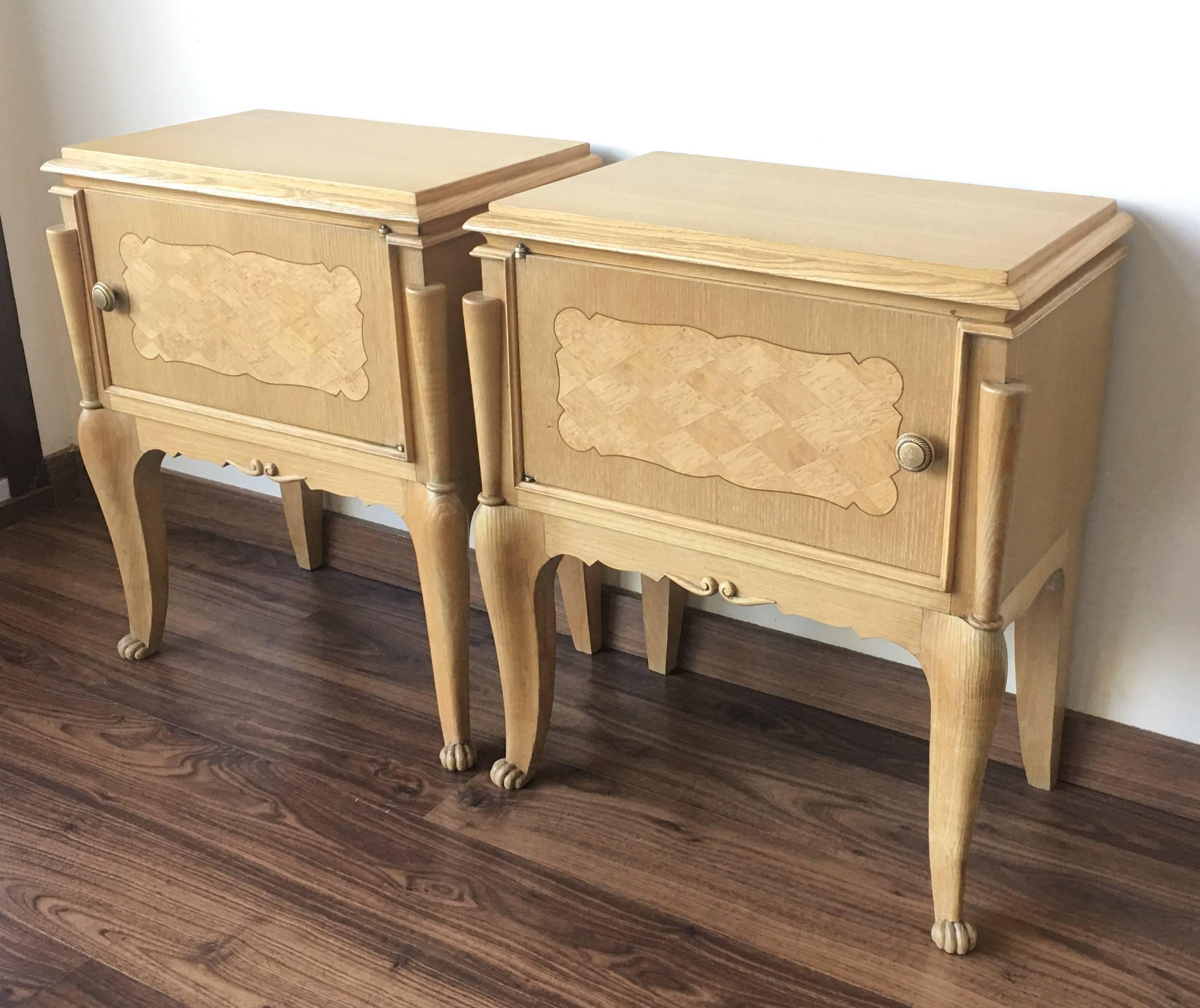 Early 20th century pair of nightstands or side tables with one door and marquetry for a plenty of storage to hold anything you may want close at hand. Original handles golden brass.
Restored and polished.