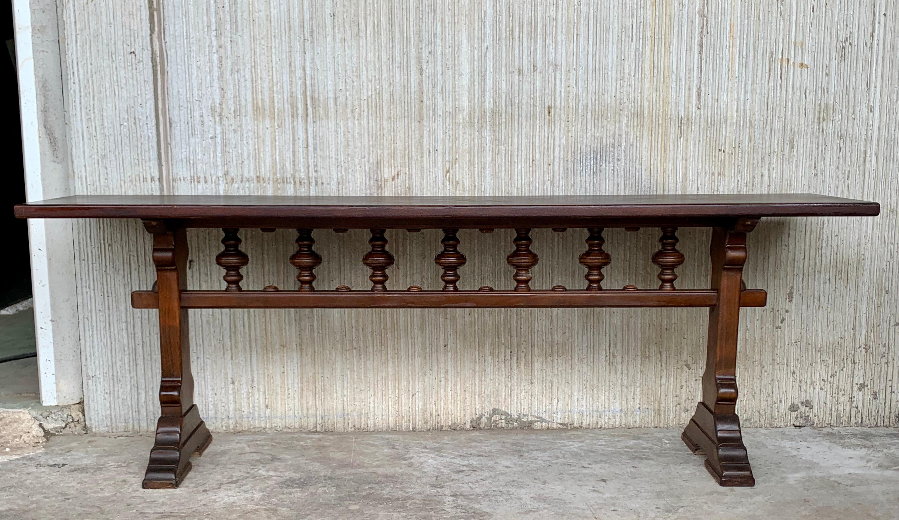 Early 20th Spanish console table with two pedestal legs joined by a carved bars stretcher.