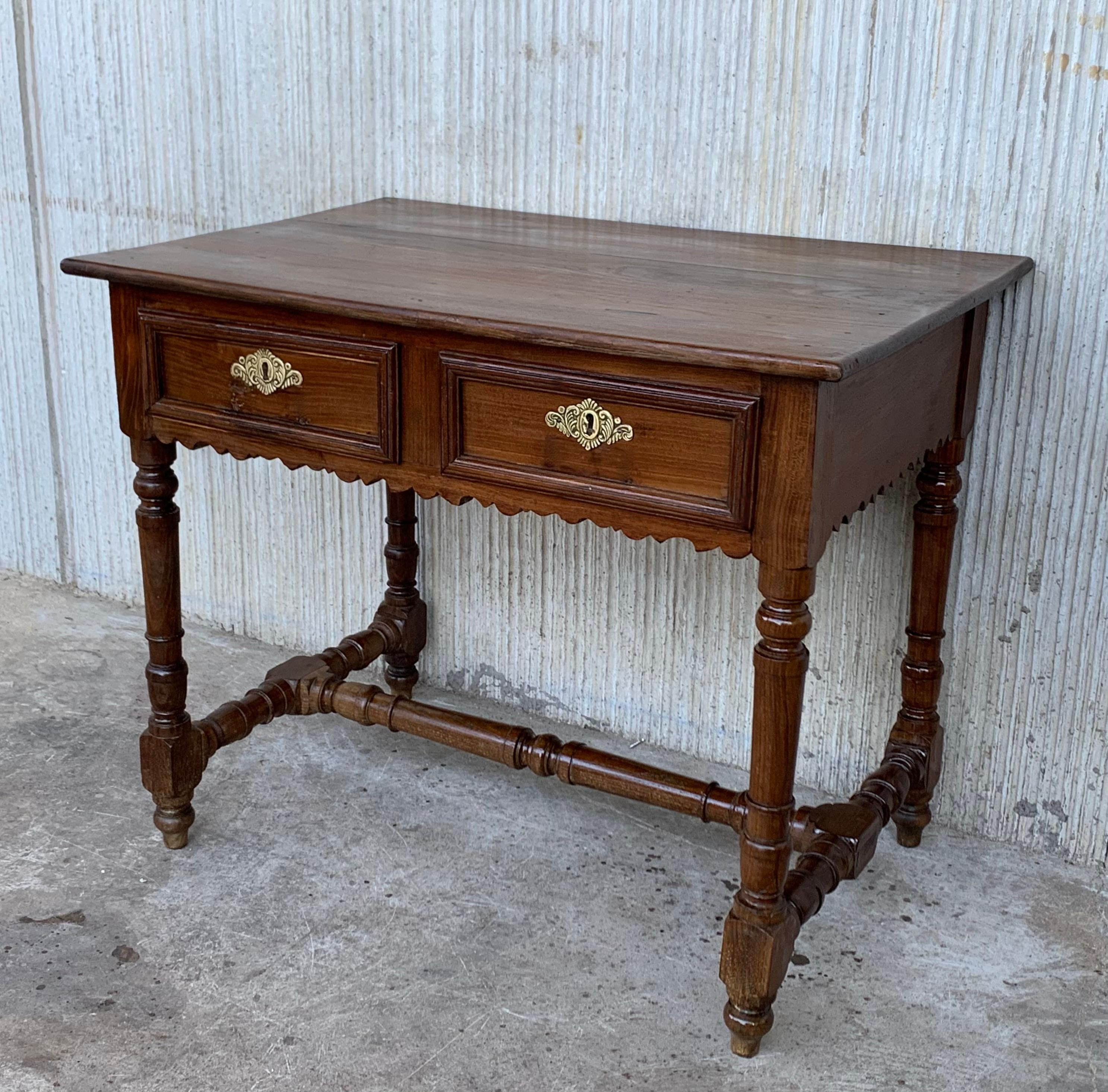 A charming early 20th century Spanish pine farm table with four tapered legs and a wonderfully well-worn finish from a century of use. Table works well for dining, but can also be used as a desk or butcher block

Height from the floor to the