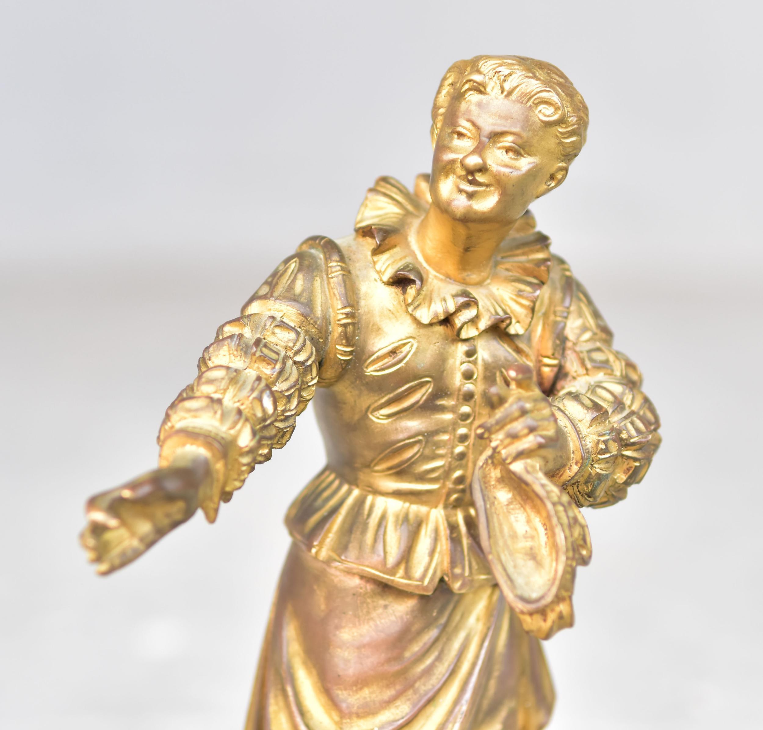 Actor de teatro en bronce dorado firmado Greil sobre base de ónice.