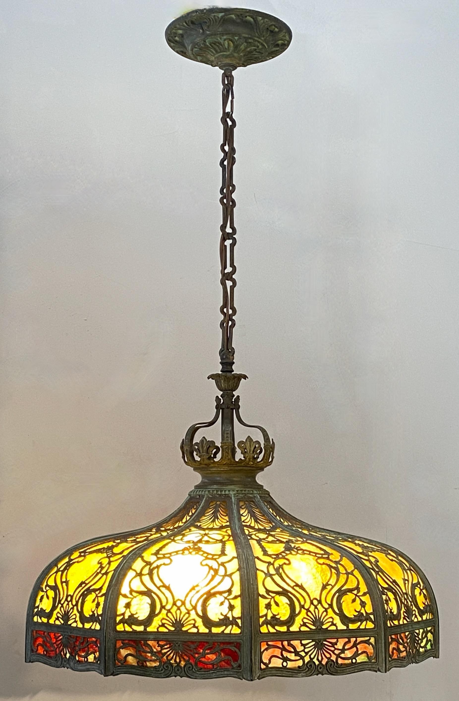 An exceptional quality large dome shape glass panel hanging pendant light fixture. In excellent original condition. Currently has the original 5 socket cluster. 
The drop with the chain and canopy measures 38 inches long. We can shorten the chain