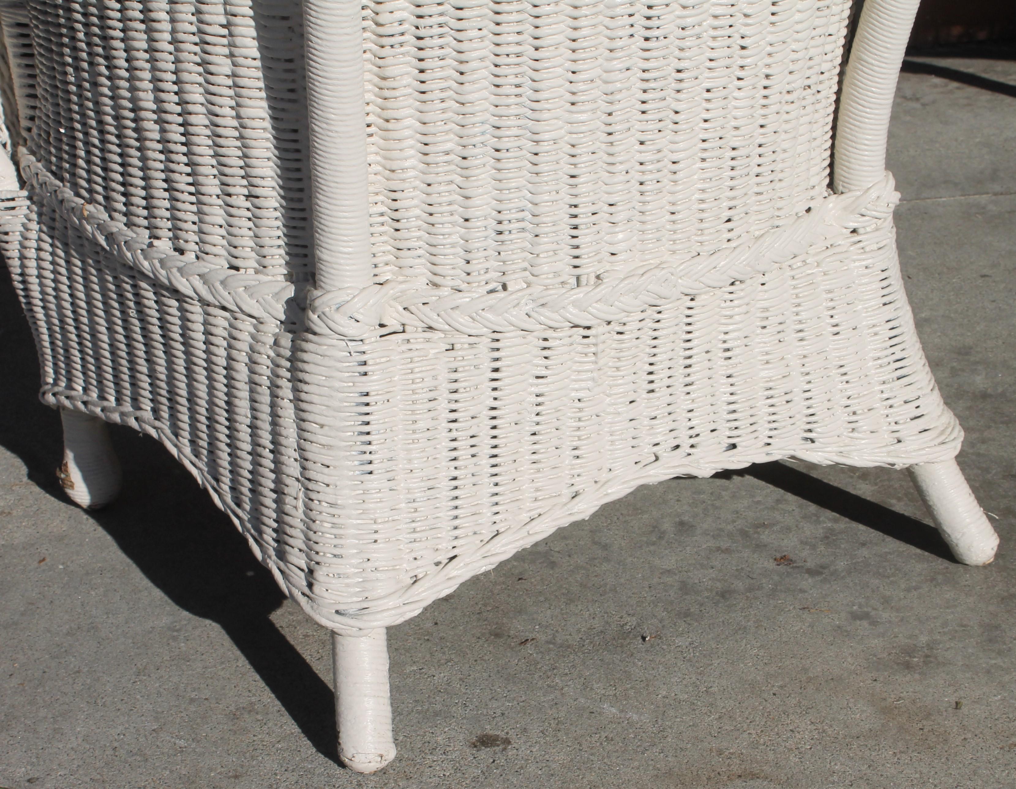 This early 20thc Bar Harbor, Maine fan back white wicker chair in amazing as found condition. This fine indoor or outdoor wicker chair was most readly found on a porch or patio. We had a vintage ticking cushion made for the chair with a zipper for